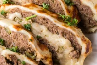 Philly Cheesesteak Stuffed Meatloaf with Caramelized Onions and Bell Peppers