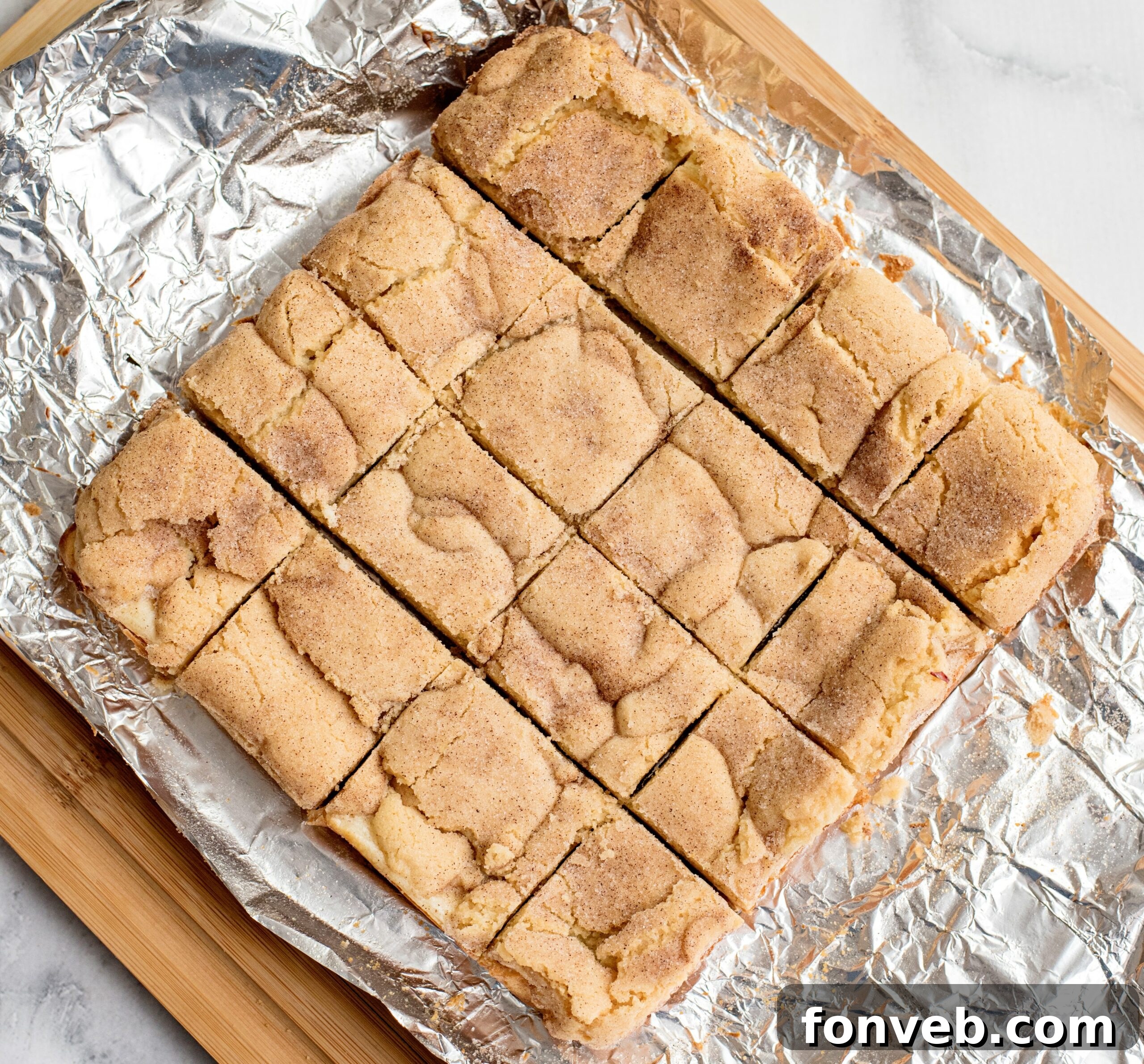 Snickerdoodle Cheesecake Bars with a golden Oreo crust visible