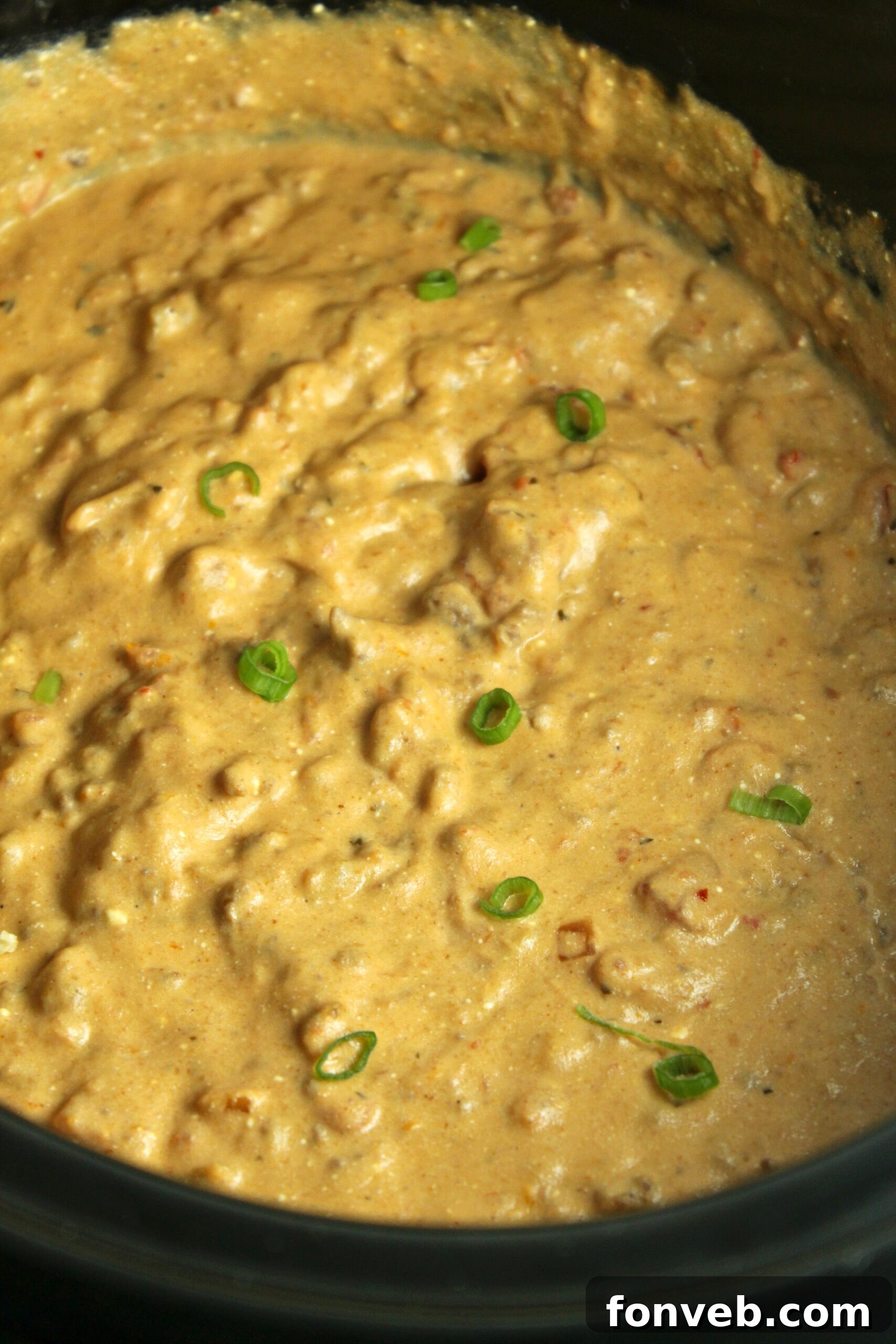 Preparing the taco dip ingredients in a slow cooker