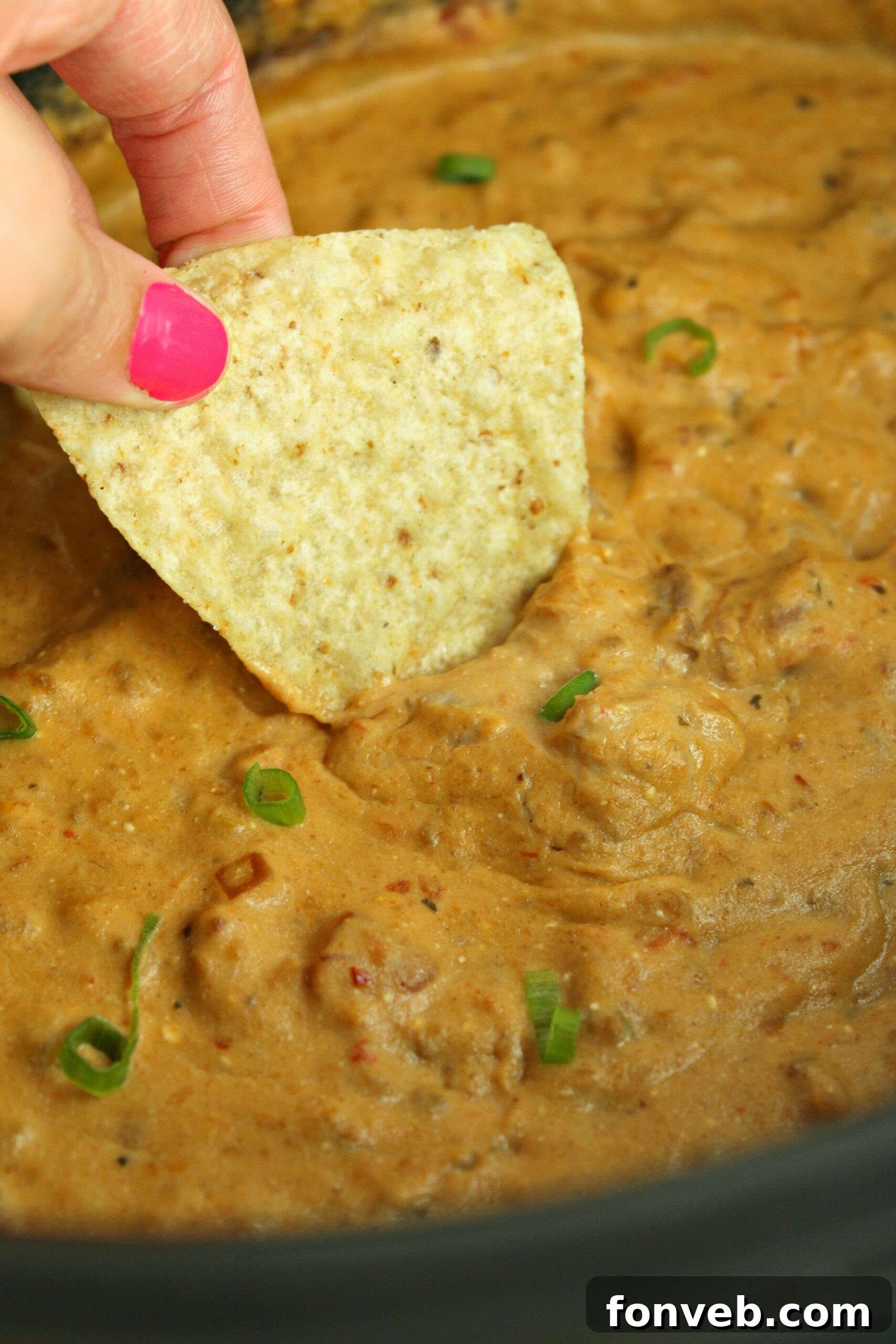 Measuring ingredients for slow cooker taco dip