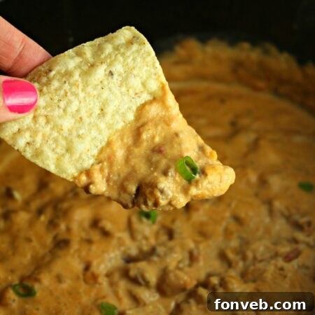 Slow Cooker Taco Dip in a rustic bowl