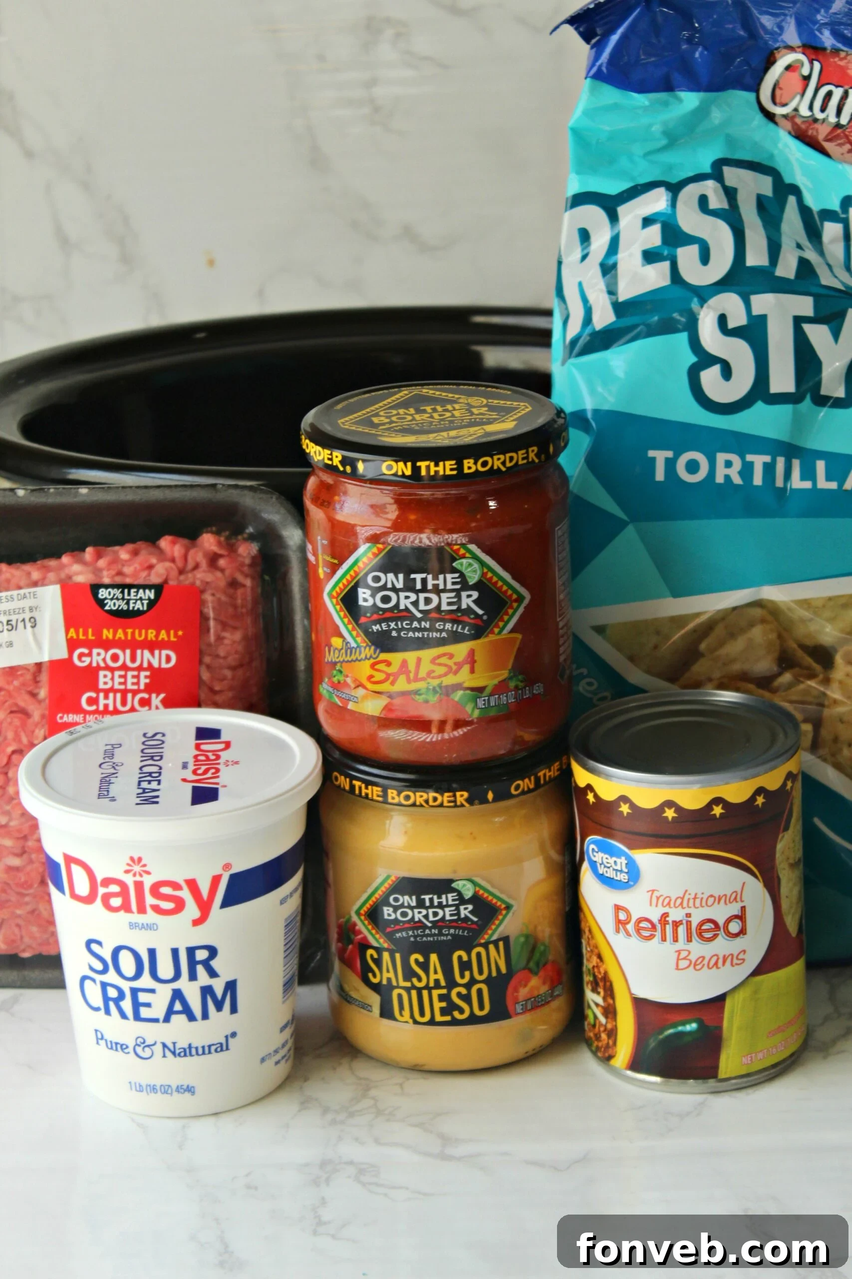 Slow Cooker Taco Dip with a serving spoon