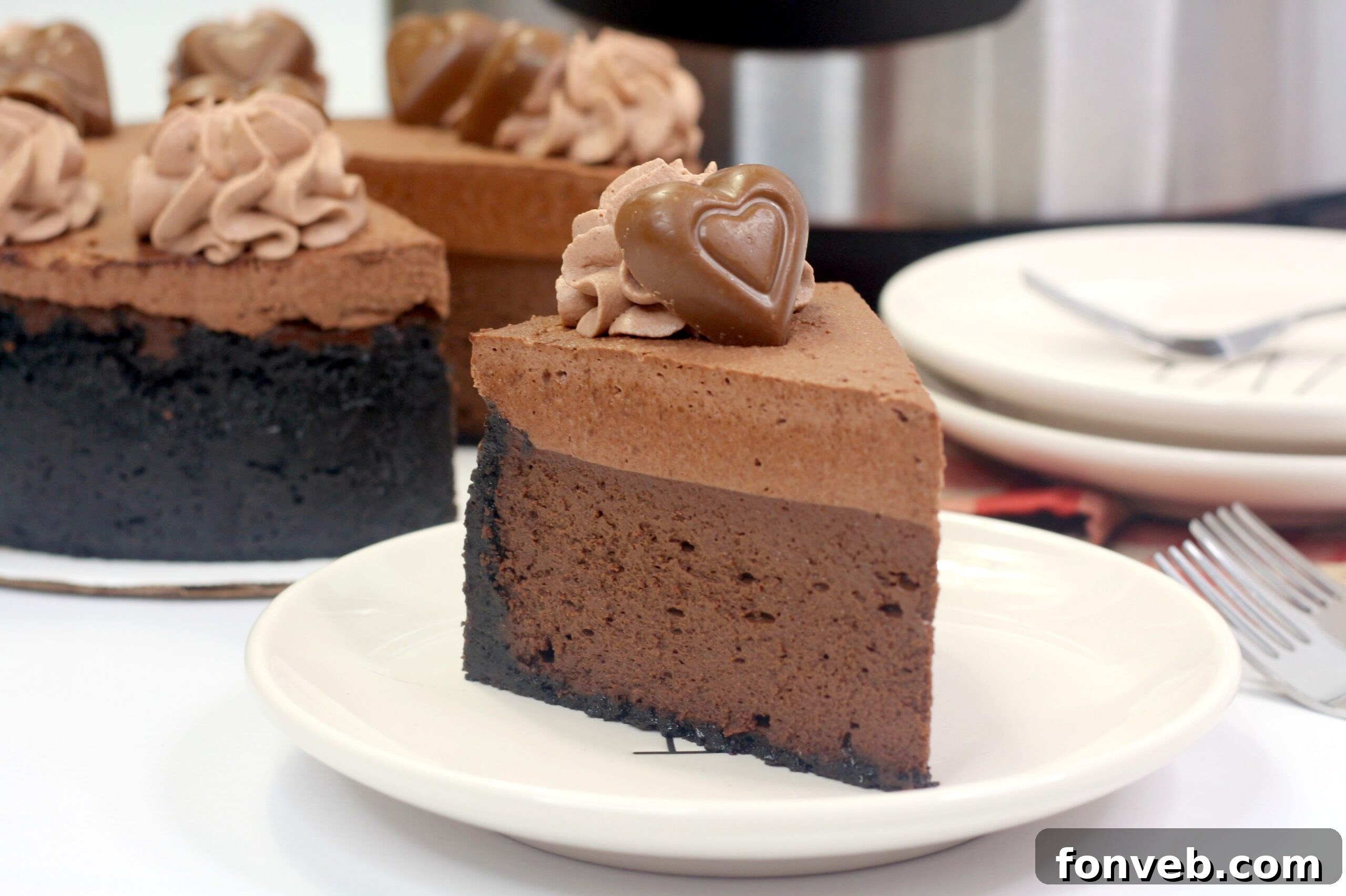 Another close-up of a slice of the layered cheesecake, showing the texture and the elegant topping.