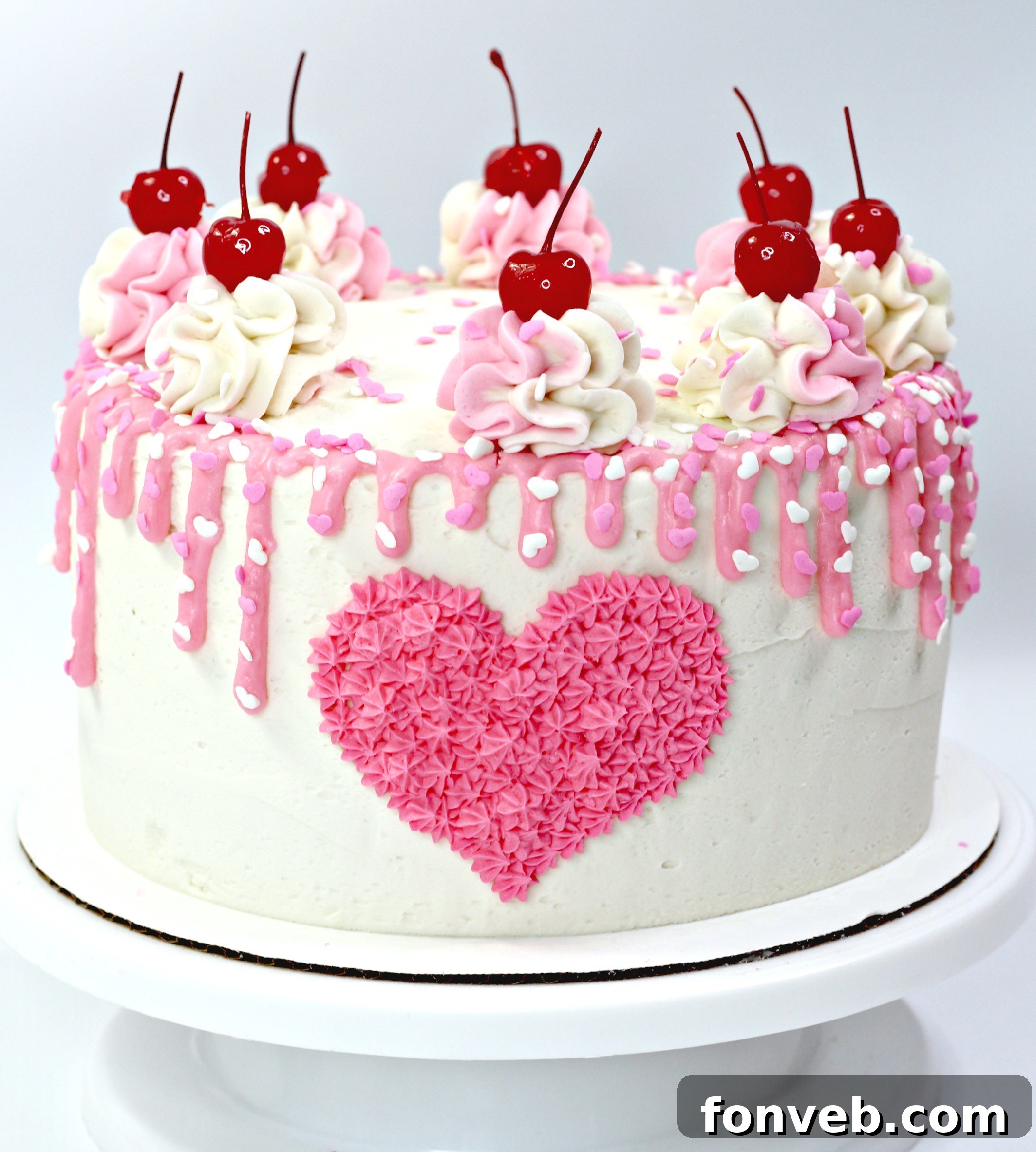 Overhead view of a Valentine’s Day Love Cake showing intricate piping and heart sprinkles on top.