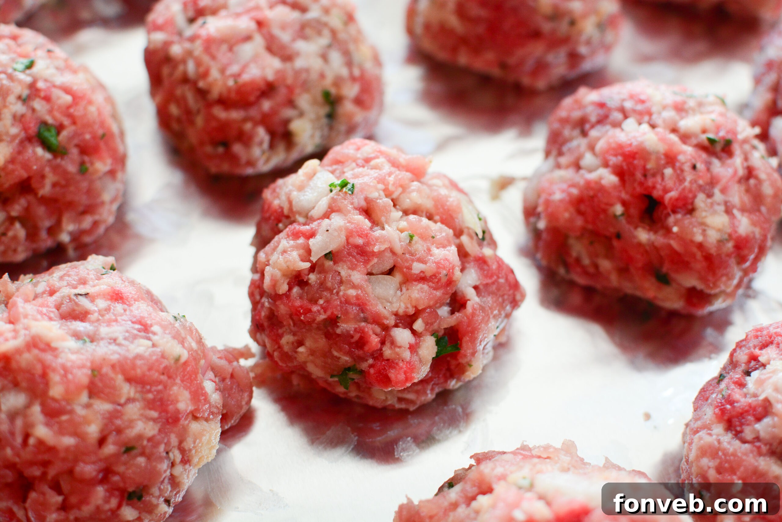 Assortment of baked Italian meatballs, ready to be incorporated into various dishes.