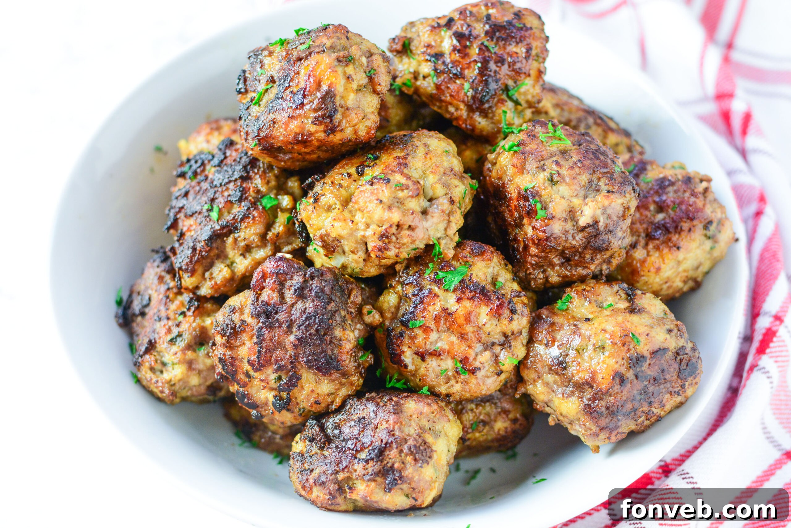 Close-up of baked Italian meatballs in a cast iron skillet, perfect for serving.