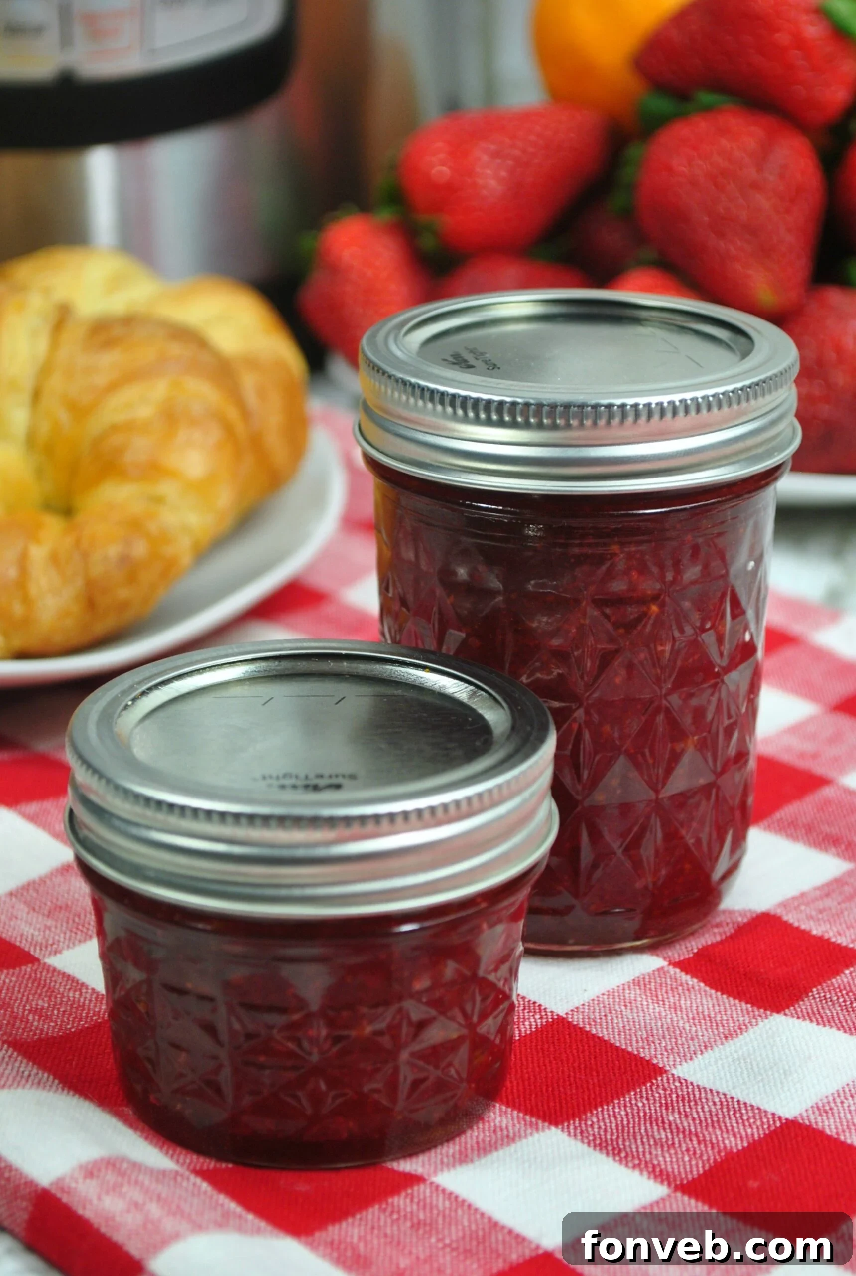 Jar of strawberry jam with a spoon, ready to be served