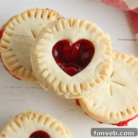 A perfectly baked mini cherry pie, showcasing its golden crust and inviting cherry filling.