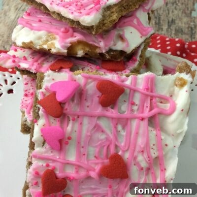Close-up of a piece of Valentine's Day Crack with pink and white chocolate and festive sprinkles.