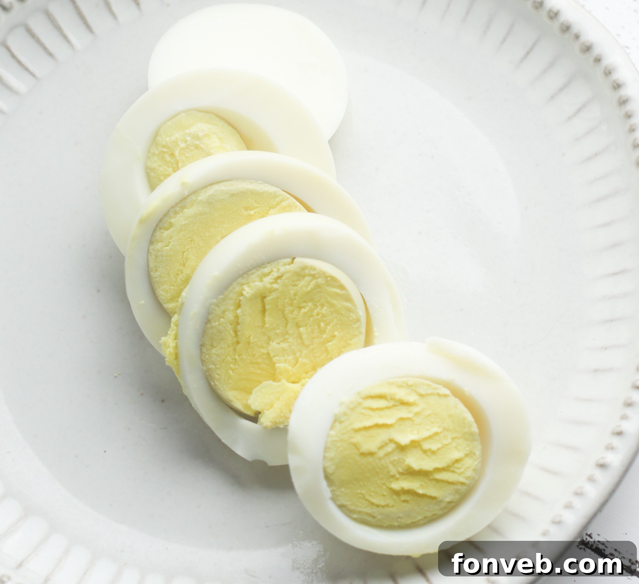 Foolproof Instant Pot Hard Boiled Eggs 3 Several perfectly cooked hard-boiled eggs on a cutting board