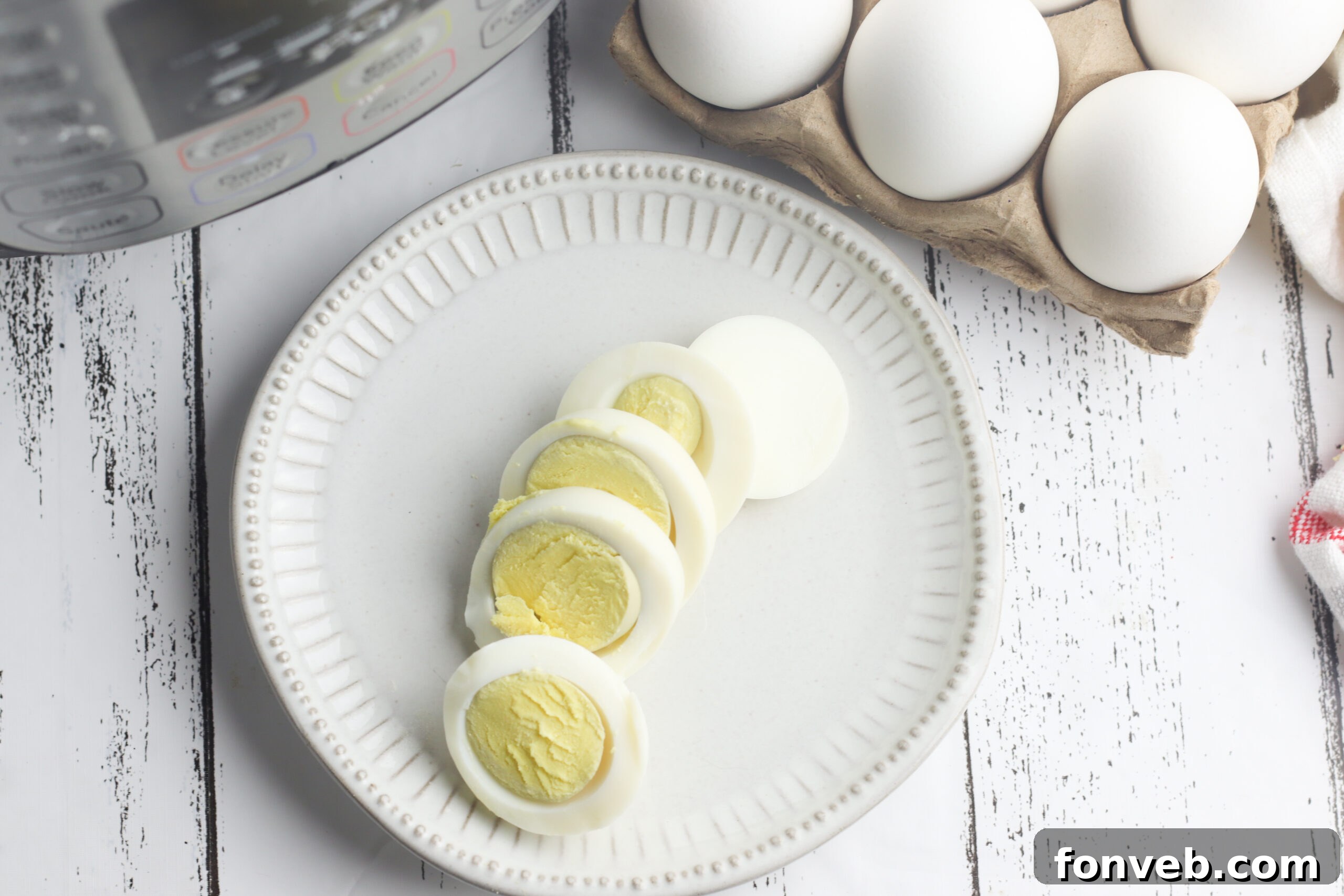 Foolproof Instant Pot Hard Boiled Eggs 8 Hard-boiled eggs being peeled on a cutting board