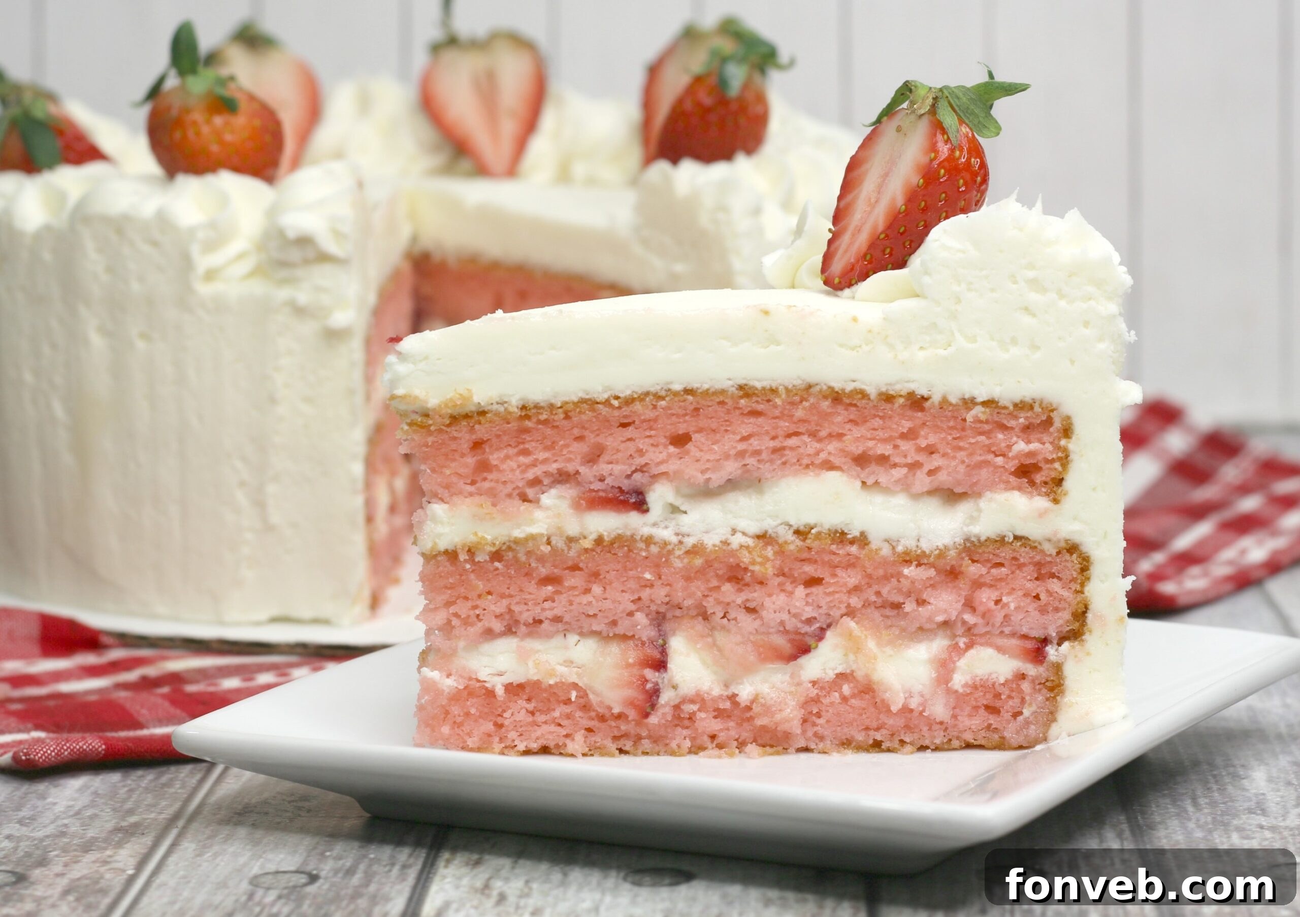Moscato Infused Strawberry Cake with Cream Cheese Buttercream 5 Close-up of a beautifully decorated Strawberry Moscato Cake showing off the creamy frosting and fresh berries.