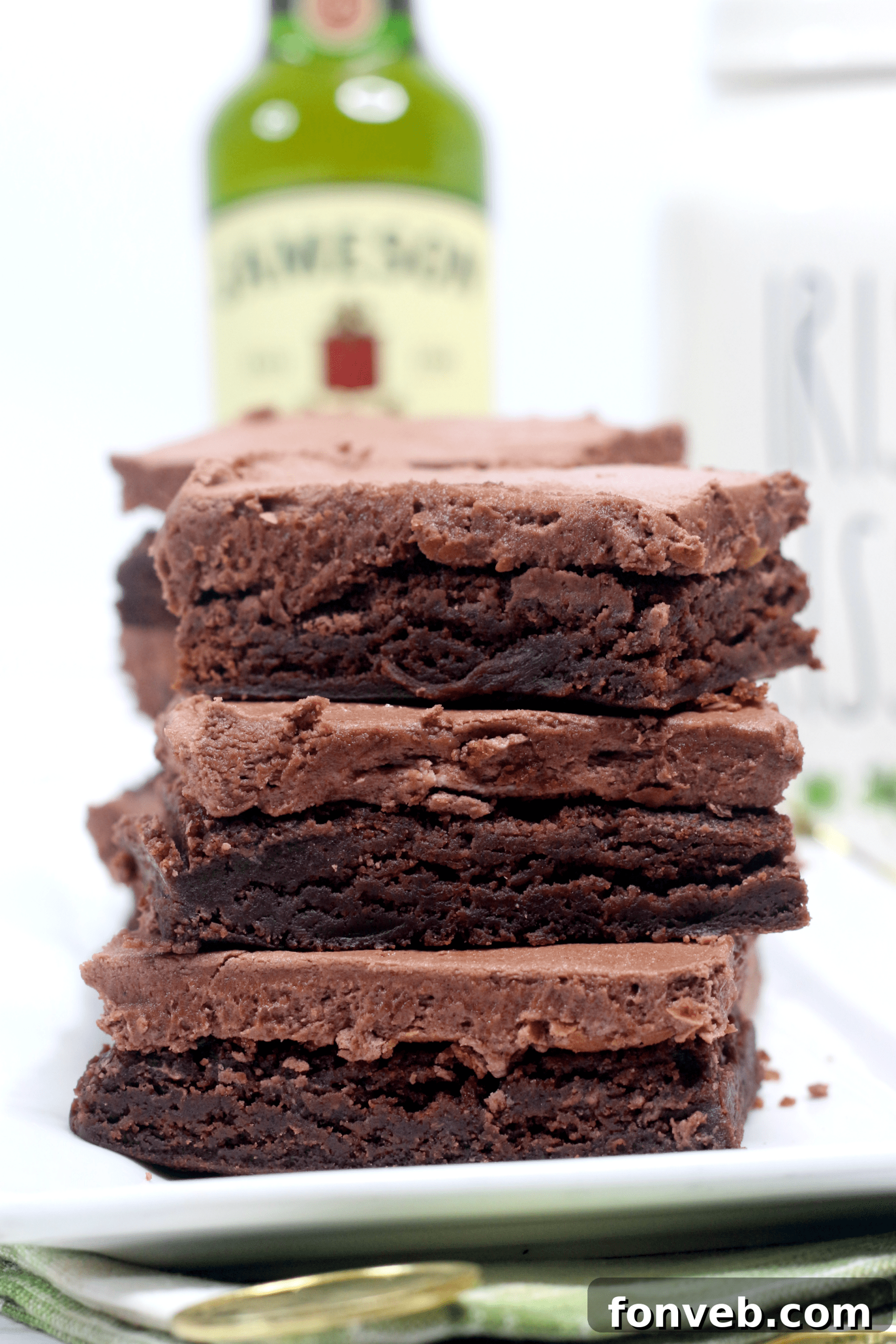 Close-up of a cut Irish Fudge Brownie showing its fudgy texture and thick frosting