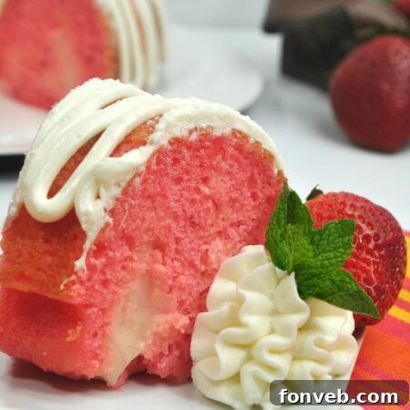 A beautifully garnished Strawberries & Cream Bundt Cake, ready to be served at a festive table.