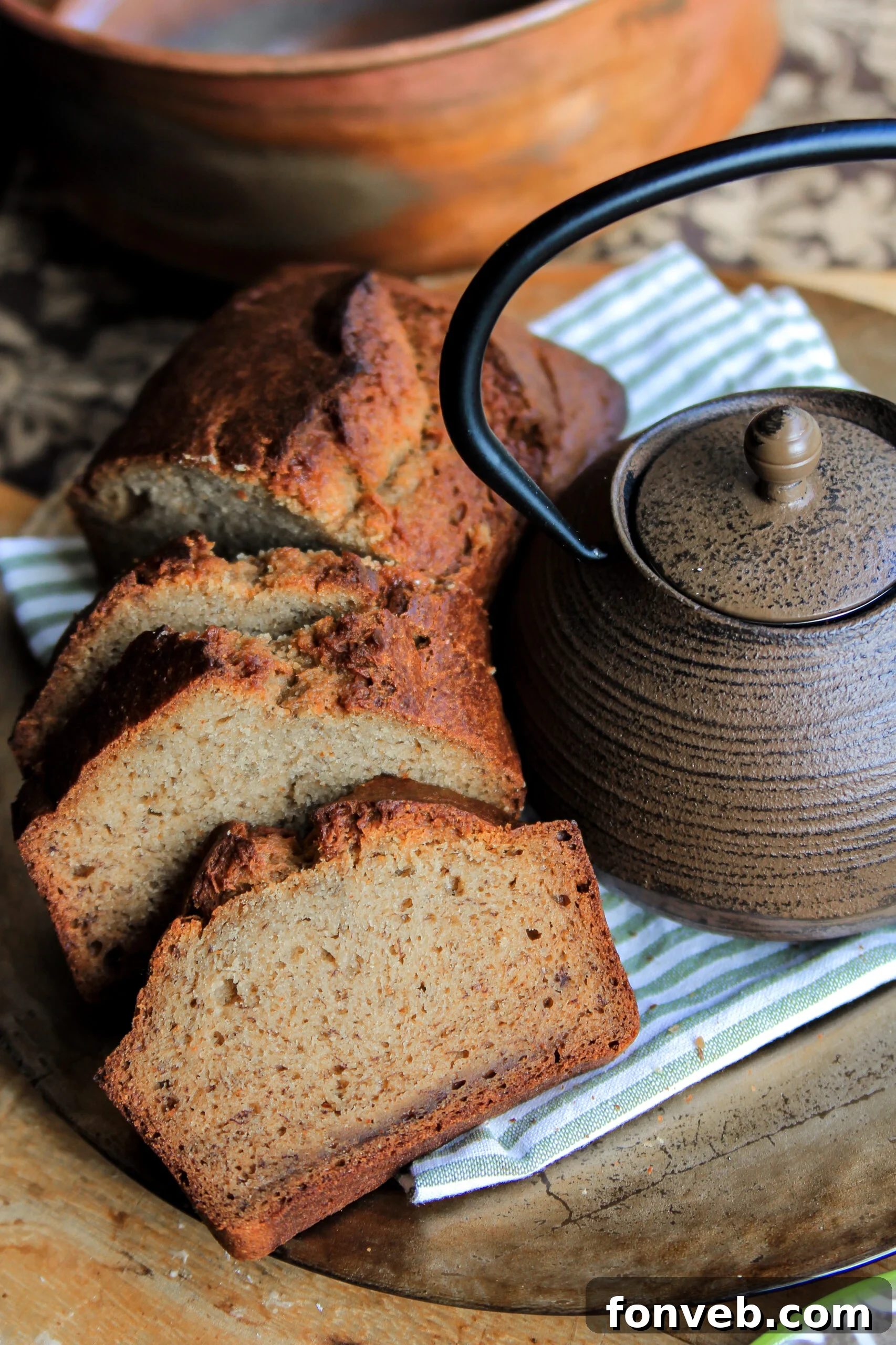 Freshly baked simple banana bread loaf on a cooling rack, golden brown and inviting