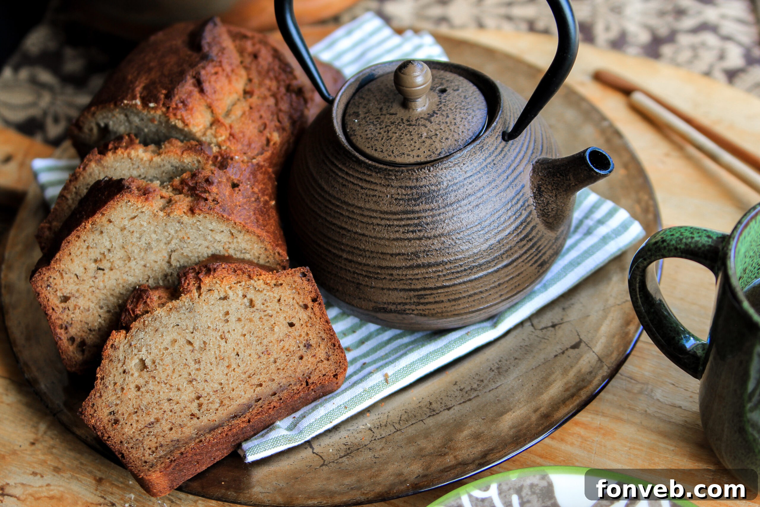 A delectable slice of banana bread sitting on a white plate, ready to be enjoyed