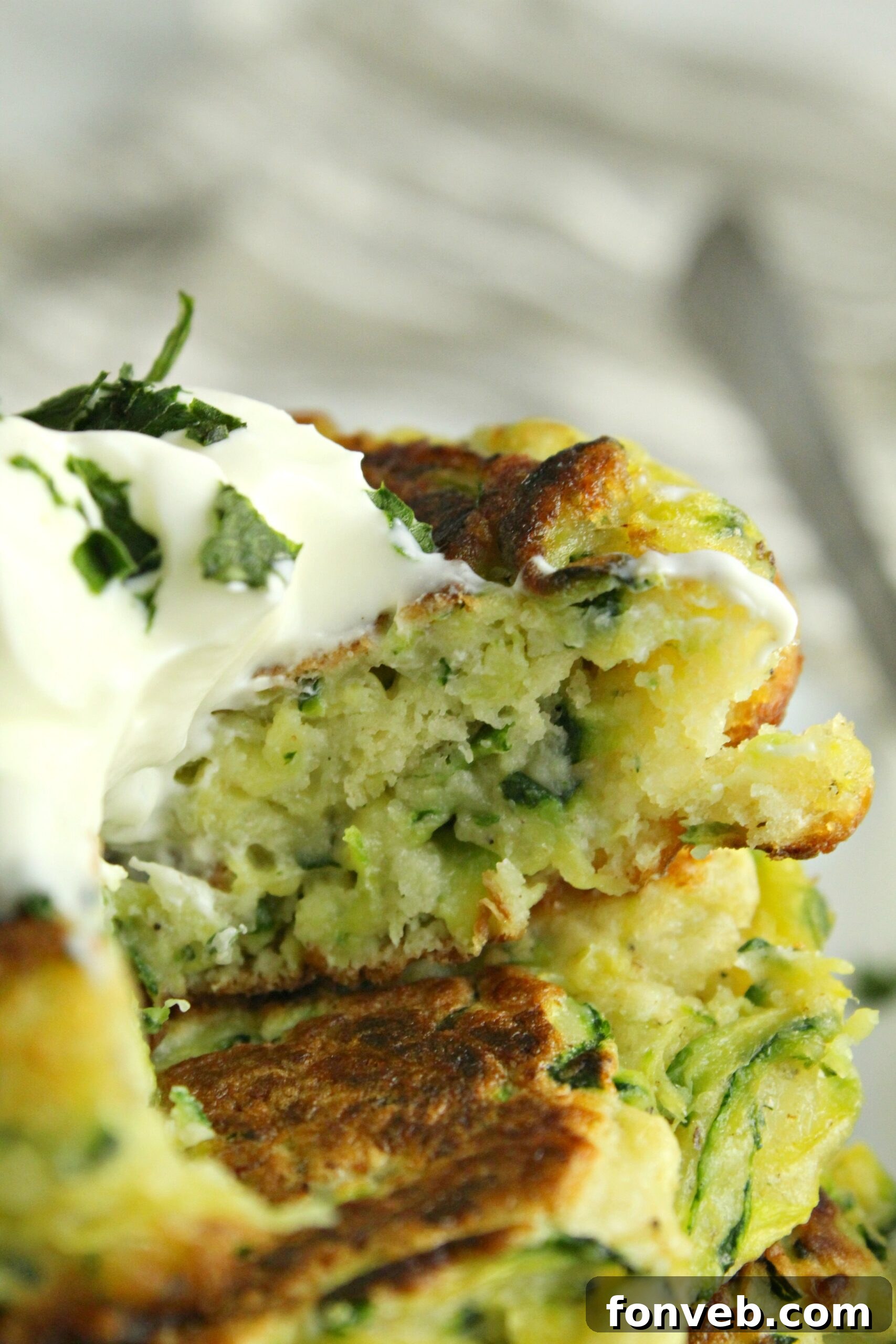 Cooked cheesy zucchini pancakes arranged on a baking sheet, ready to be served