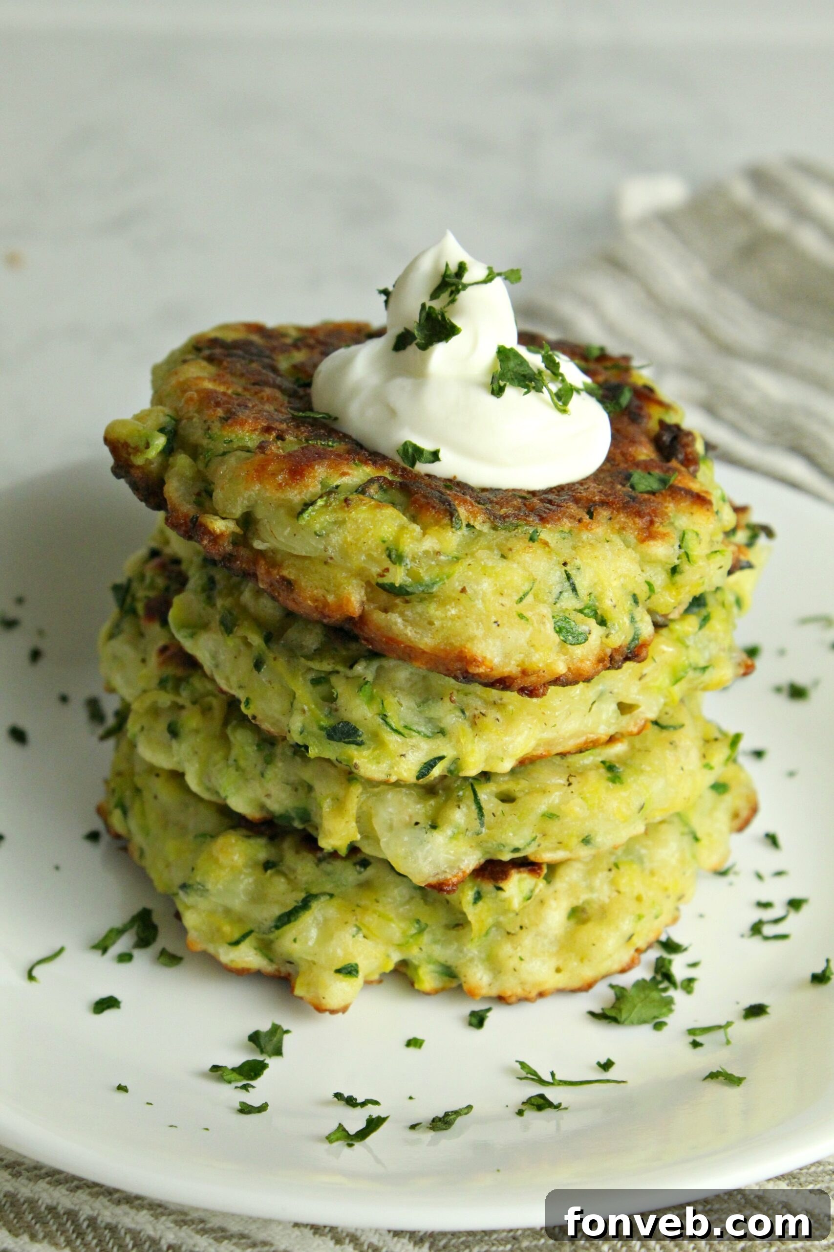A final close-up of cheesy zucchini pancakes with fresh parsley