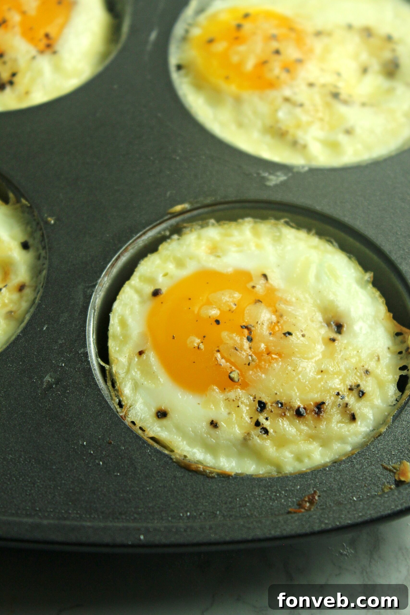 The Perfect Oven Fried Eggs 9 A plate of baked fried eggs with various toppings