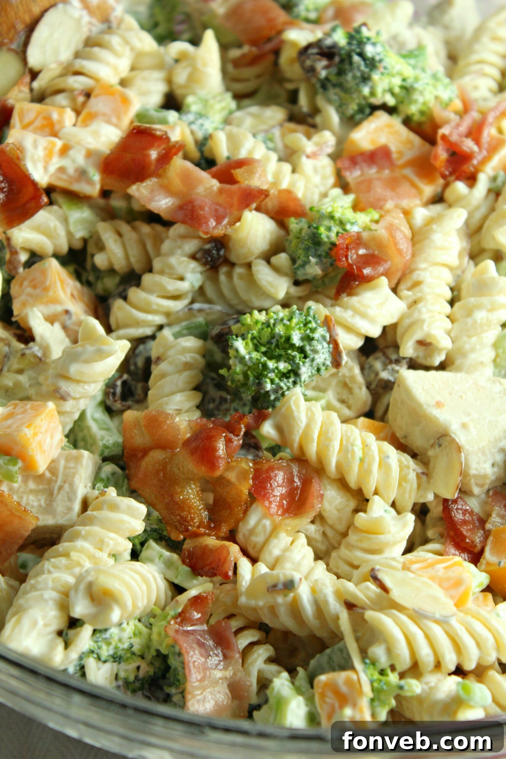 Chicken Bacon Broccoli Pasta Salad in a bowl being scooped