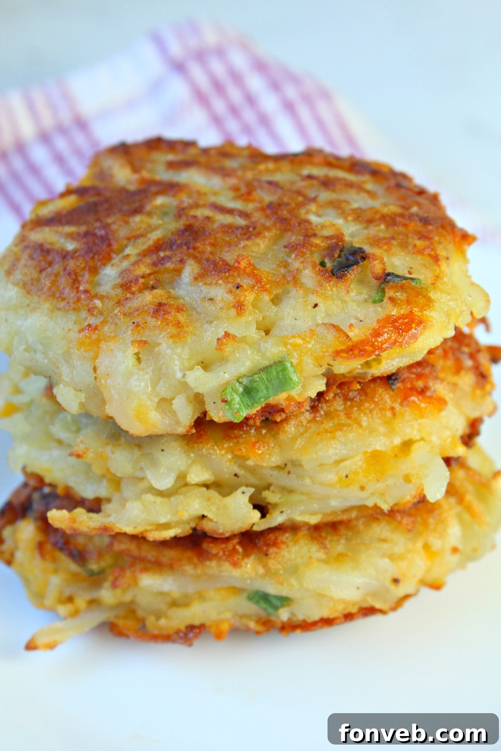 Ingredient shot of potatoes, cheese, flour, and egg for hash browns.