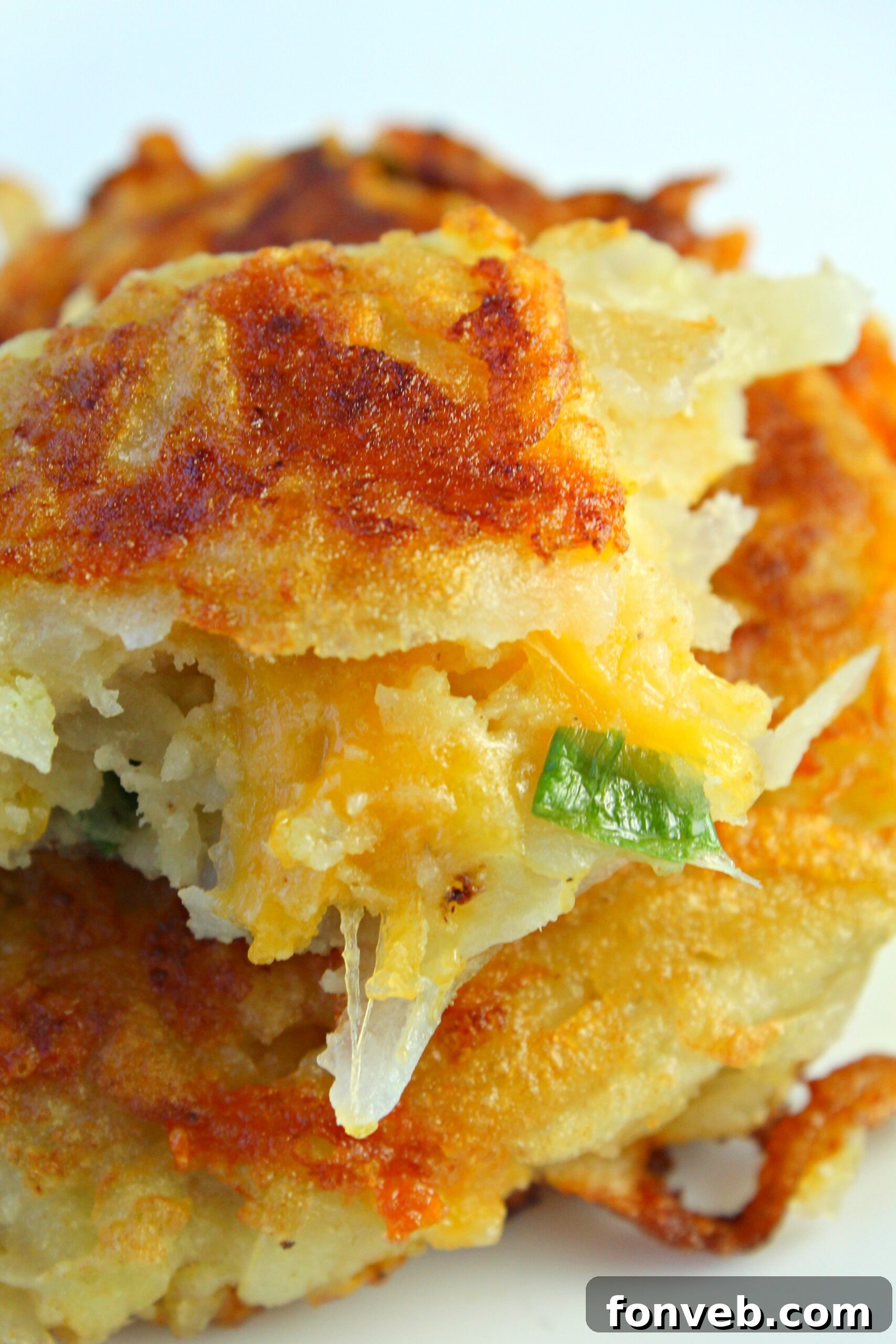 Freshly cooked crispy hash brown patties draining on paper towels.