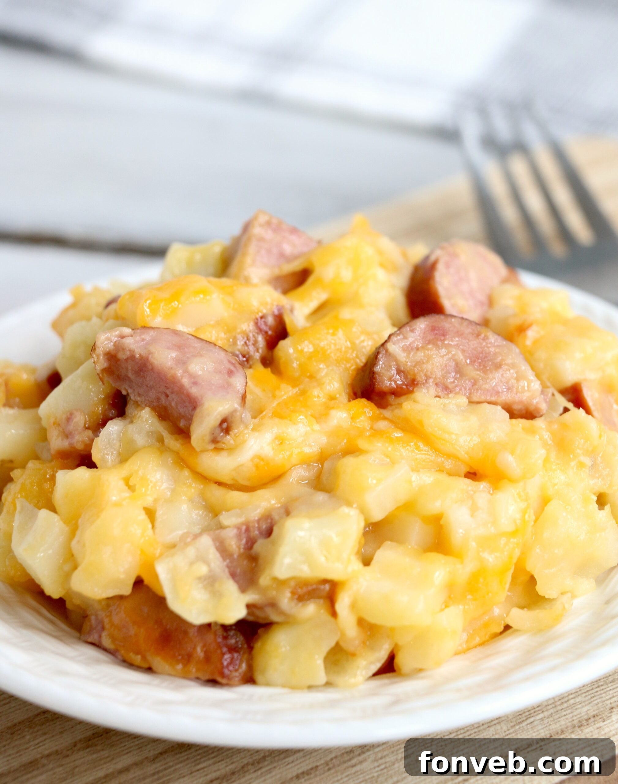 Close-up of the cheesy, bubbling Slow Cooker Kielbasa Hashbrown Casserole in the slow cooker.
