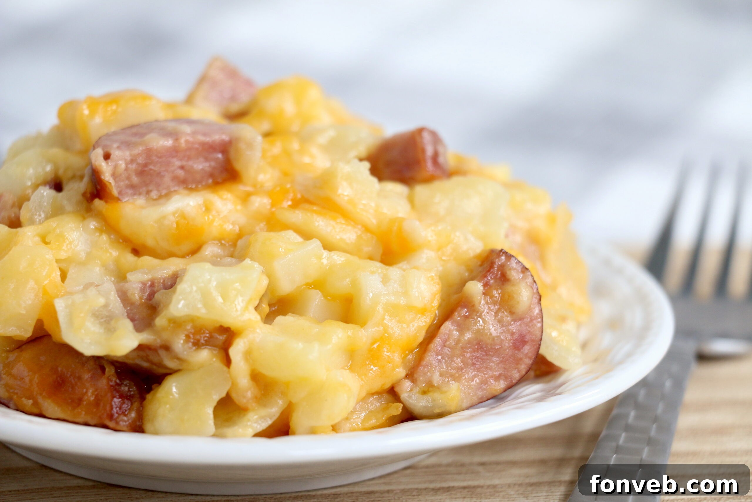 A wider shot of the Cheesy Kielbasa Hashbrown Casserole in the slow cooker, showing its generous portion size.