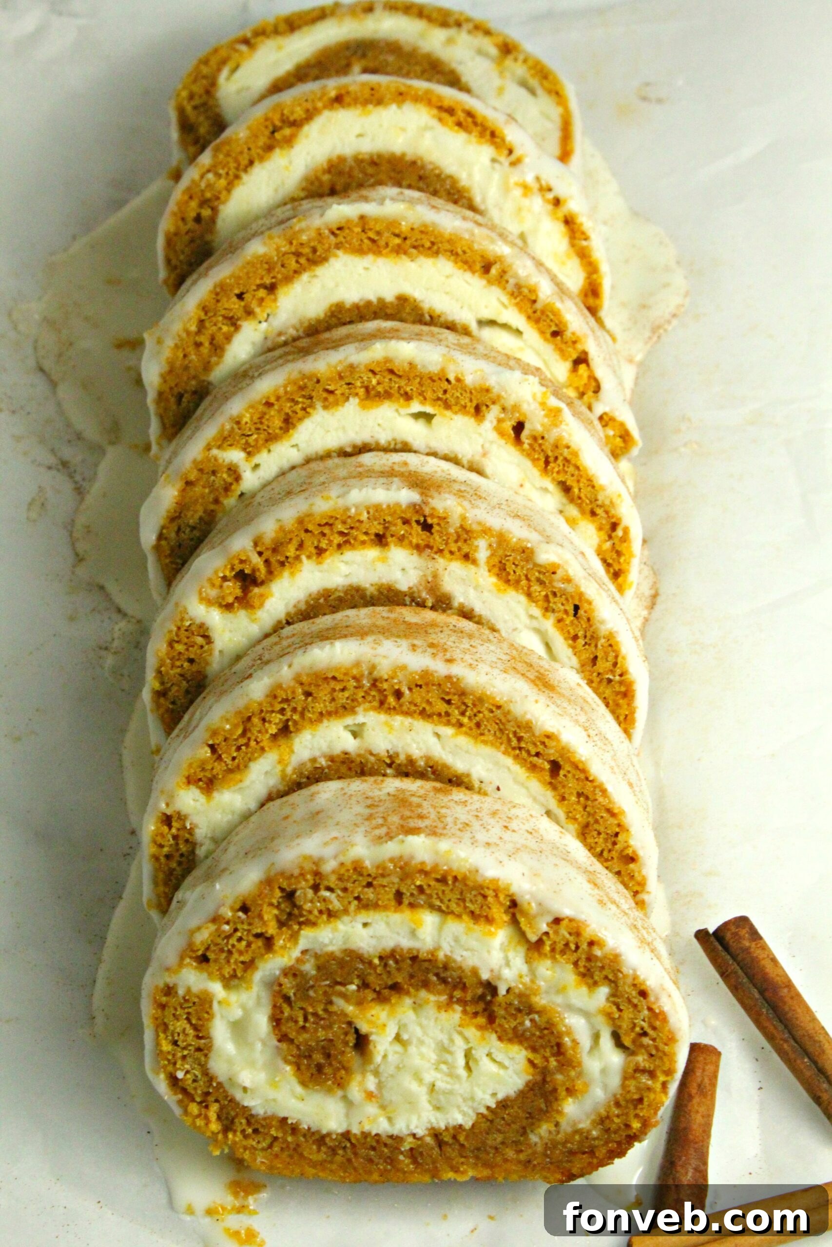 Sliced pumpkin roll presented beautifully on a white plate, ready to be served.