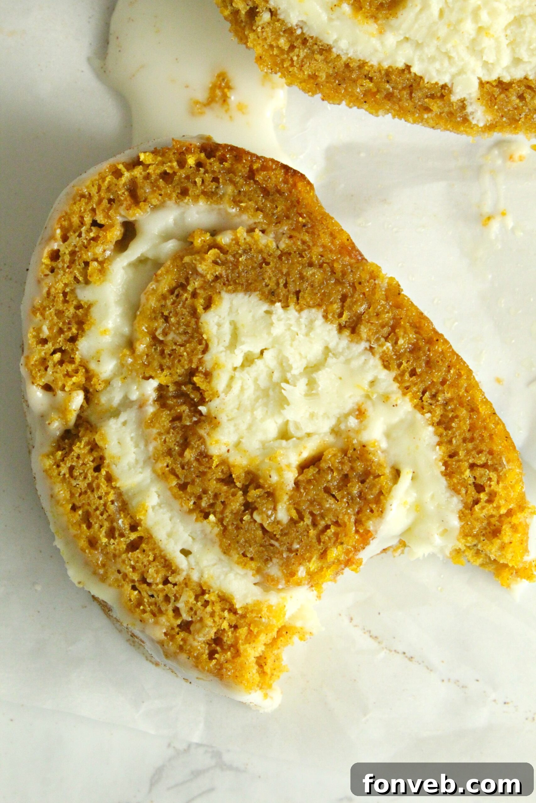 Another angle of the pumpkin cake roll, showing a generous slice.