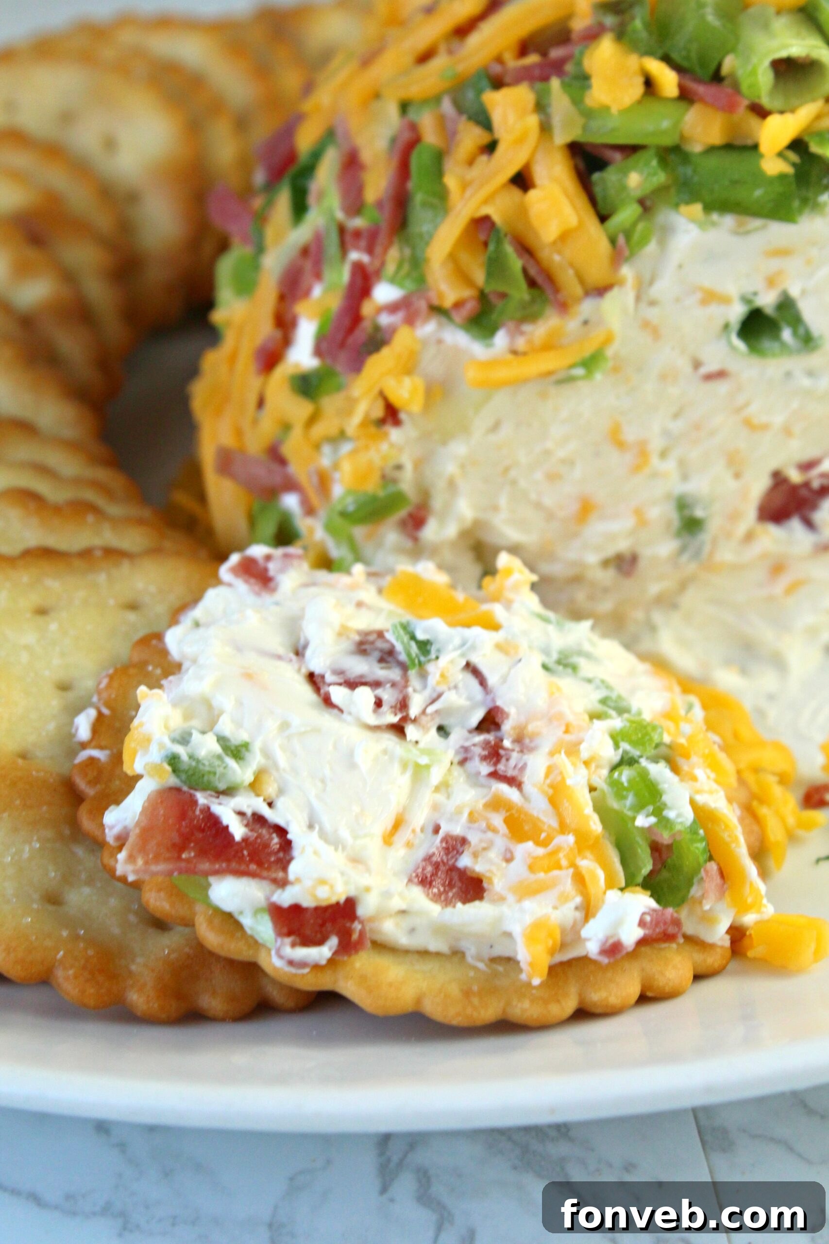 Spicy Cream Cheese Party Ball 5 A visually appealing display of the Jalapeno Popper Cheese Ball with various dippers