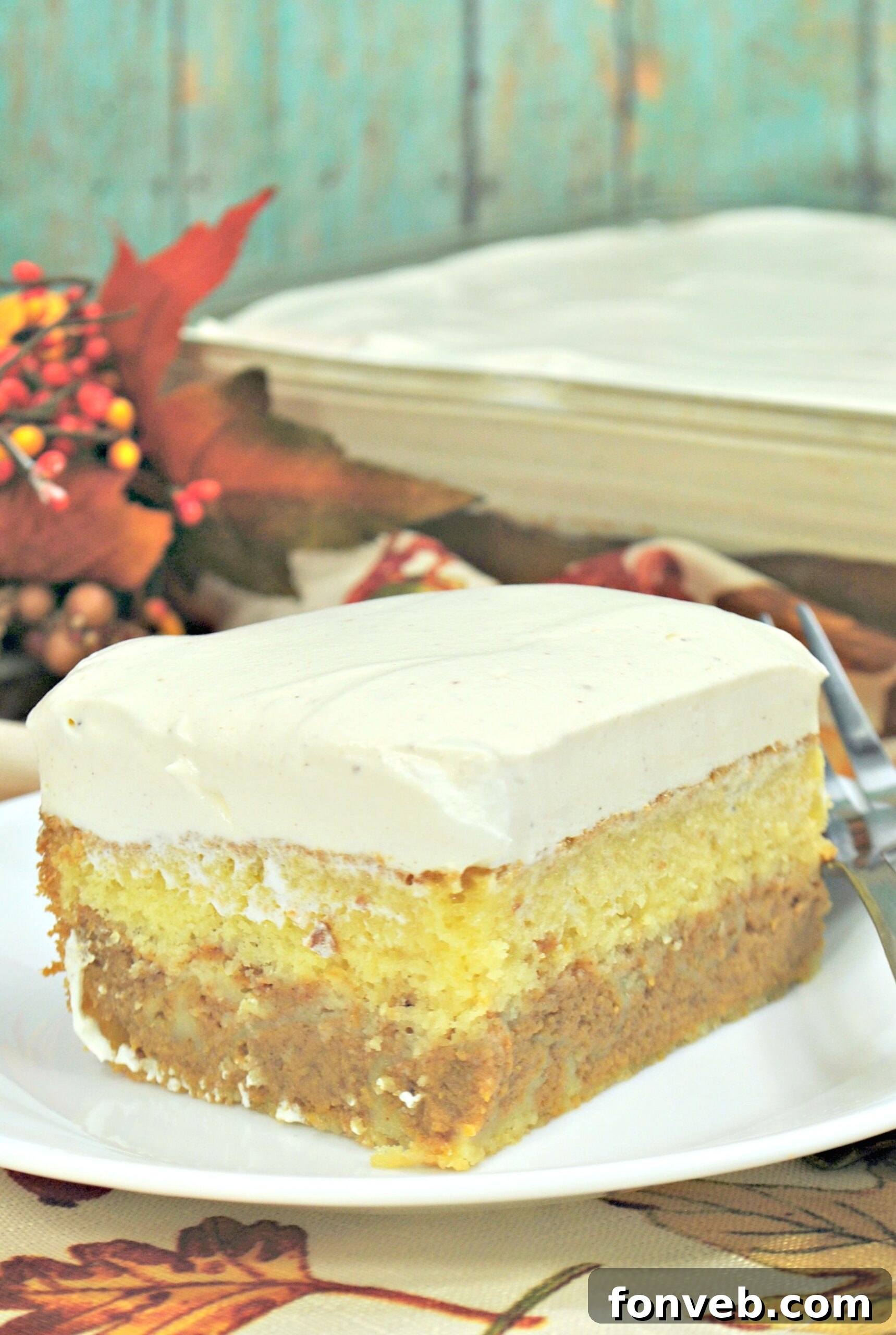 Enchanted Pumpkin Dream Cake 6 A slice of Pumpkin Magic Cake showing the rich pumpkin layer, cake base, and thick vanilla frosting.