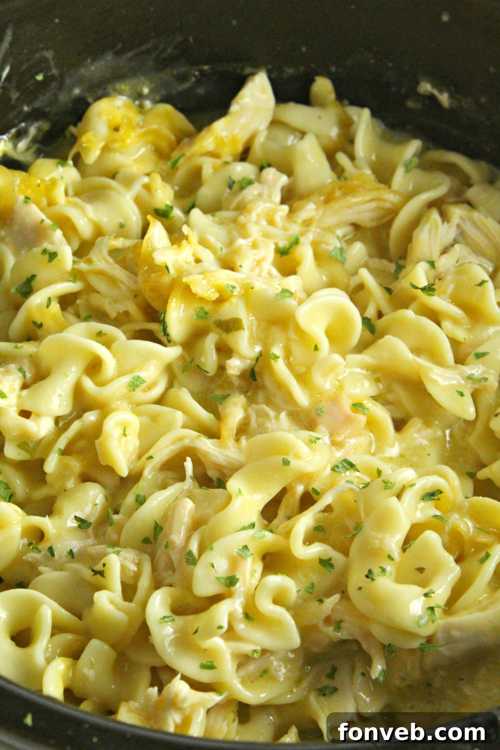 Slow Cooker Chicken and Noodles in a rustic slow cooker, ready to be served family-style.