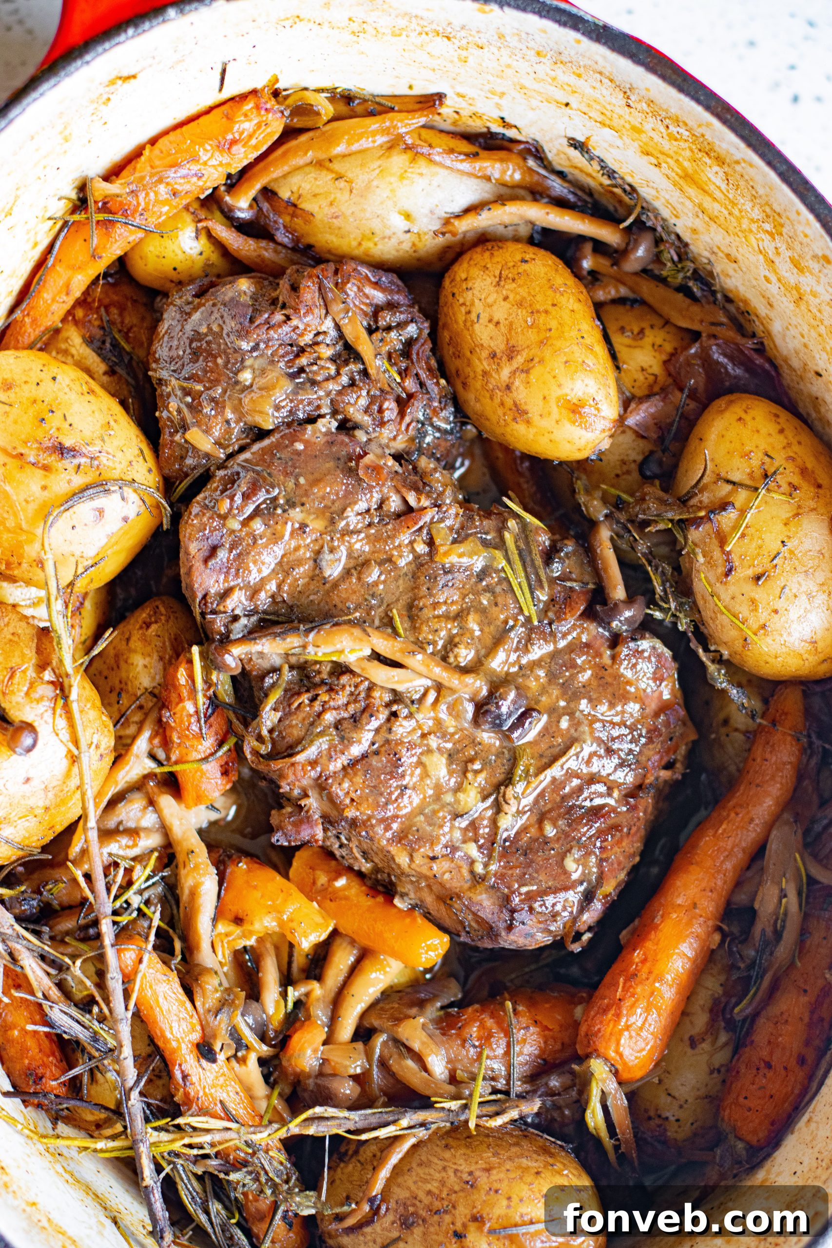 Perfectly cooked pot roast with tender potatoes and carrots, ready to serve in a Dutch oven.