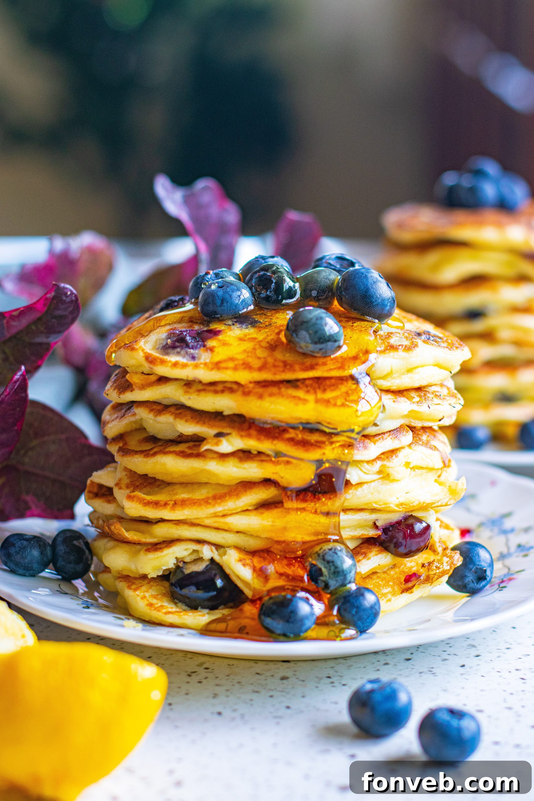 A close-up shot of a single blueberry cream cheese pancake, highlighting its golden exterior and the visible, juicy blueberries embedded within.