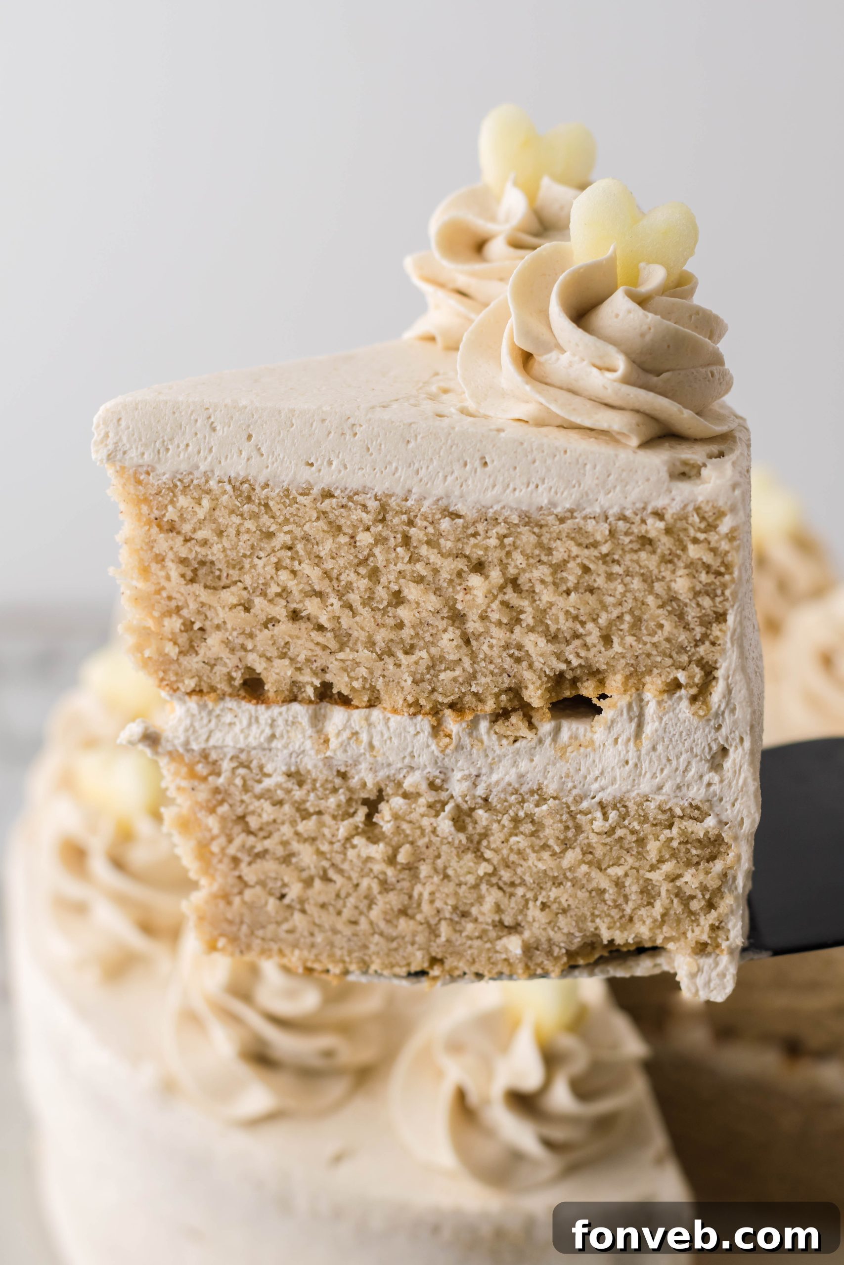 Spiced Apple Cider Cake with Caramel Frosting 5 Apple Cider Cake slice on a white plate with fork.
