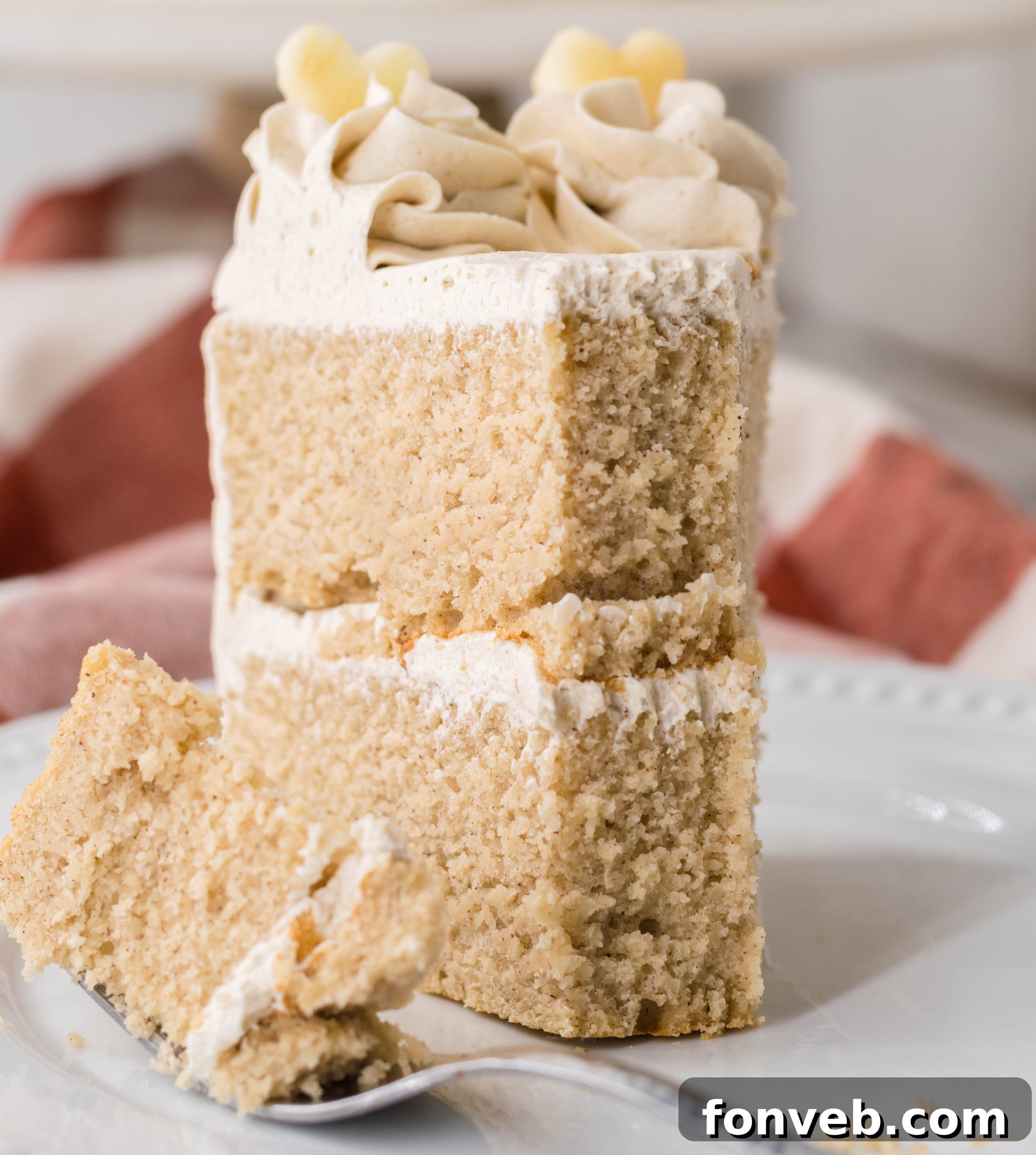 Spiced Apple Cider Cake with Caramel Frosting 8 A beautifully frosted Apple Cider Cake on a rustic cake stand.