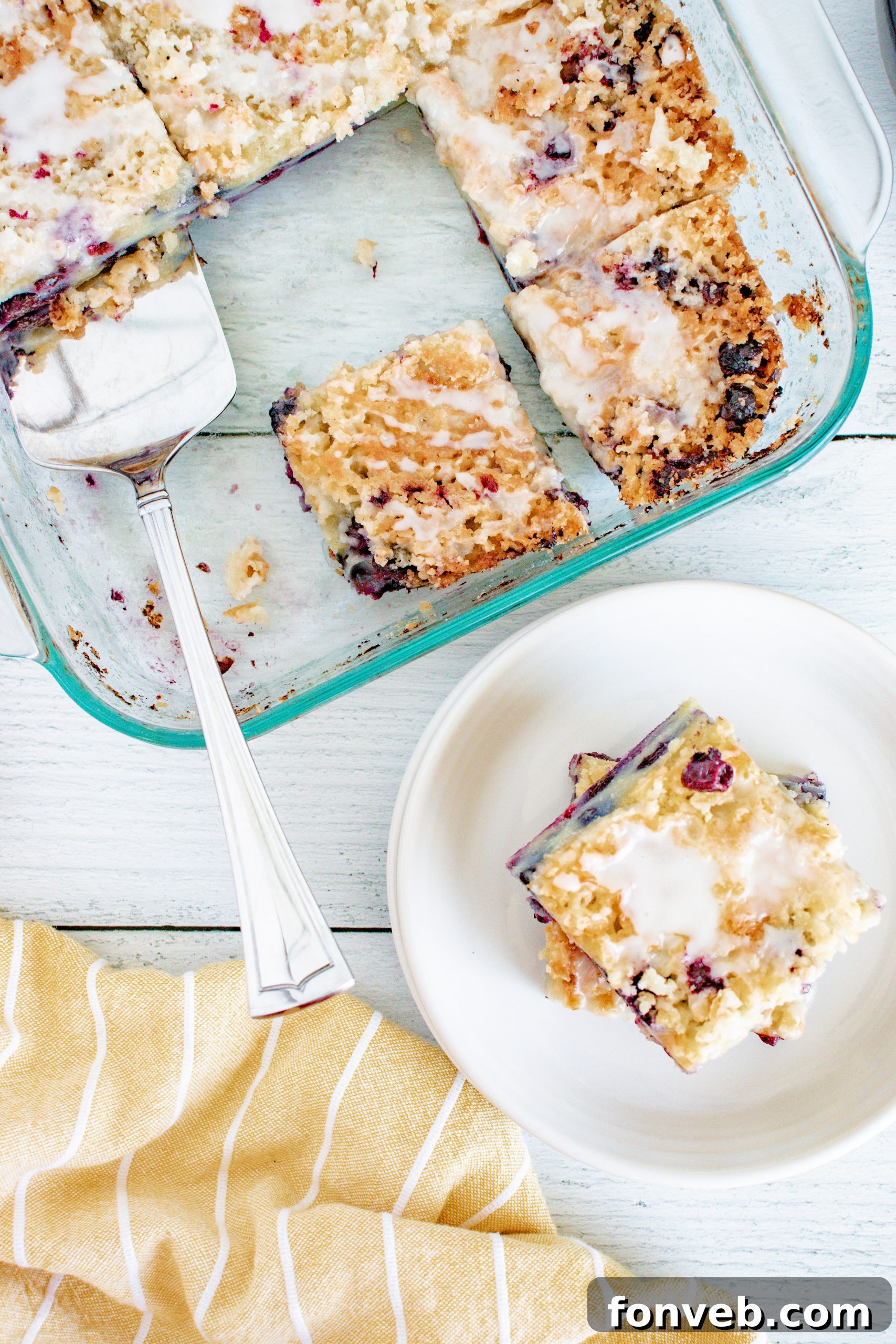 Blueberry Muffin Crumble Cake with Vanilla Drizzle 3 Blueberry Muffin Cake with streusel topping and vanilla glaze, with a focus on the fluffy texture and blueberries.