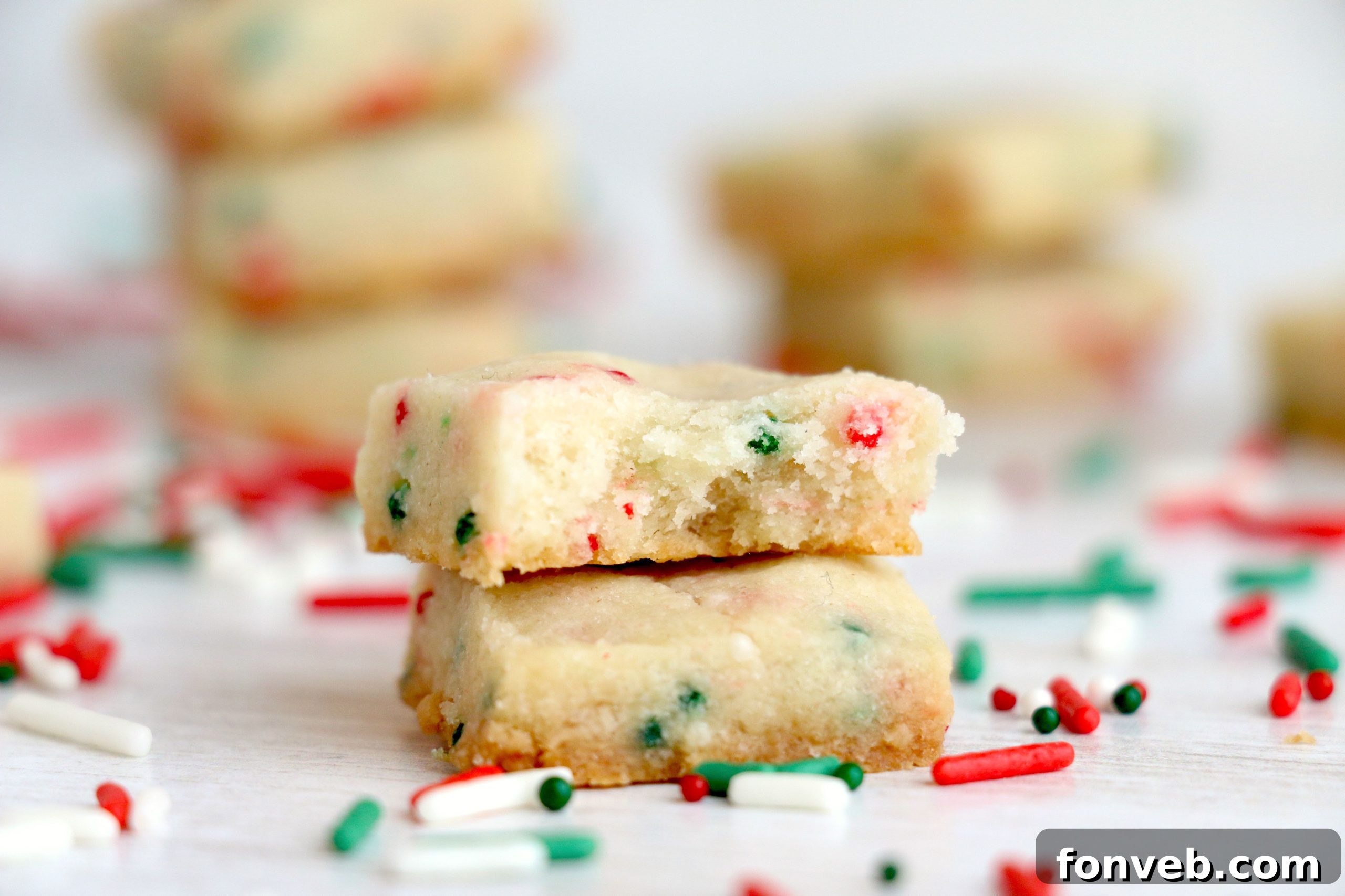 Four Ingredient Festive Shortbread Bites 6 Close-up of baked shortbread bites, showing their tender texture and the scattered festive sprinkles.