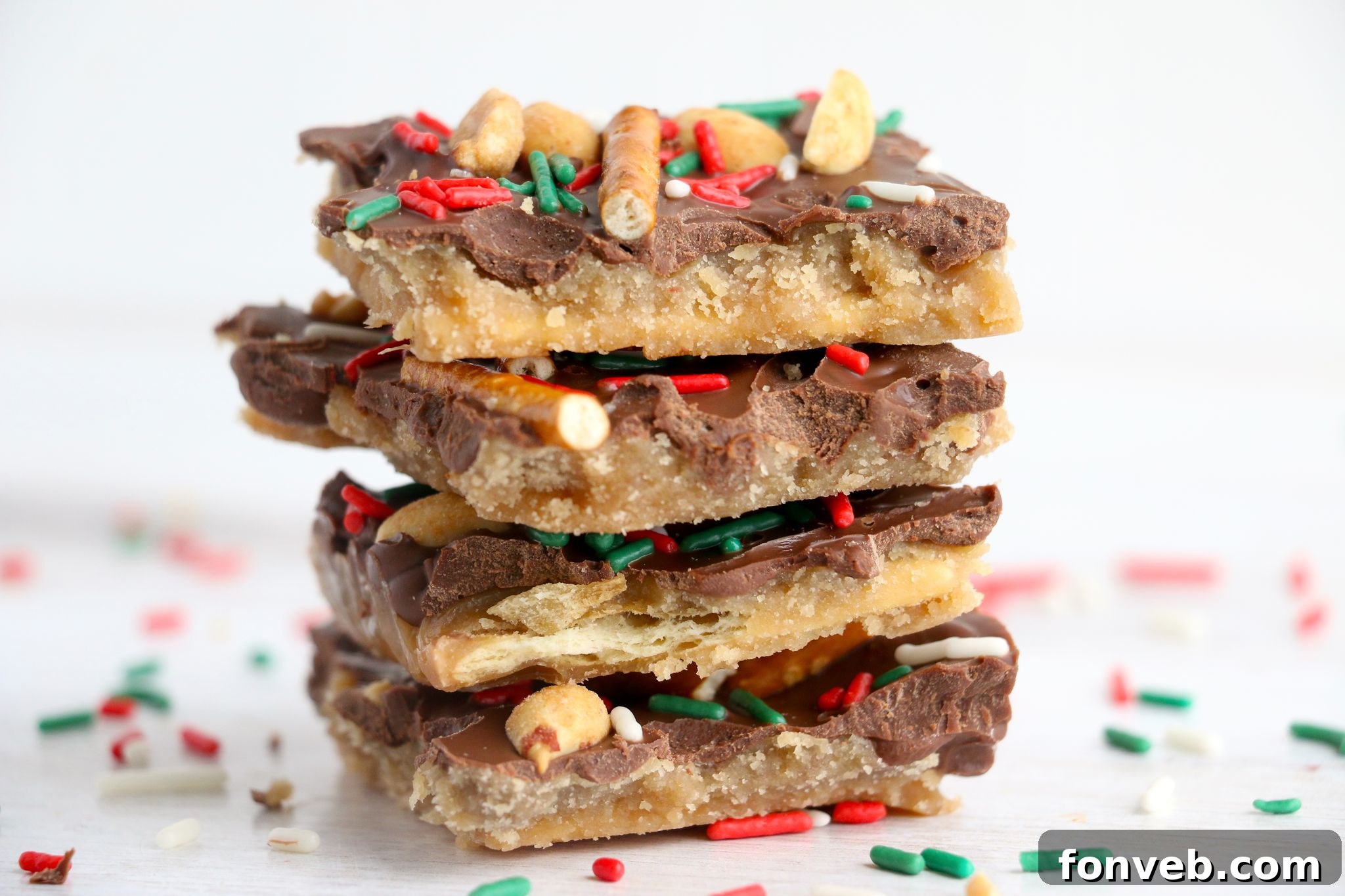 Toffee Pretzel Peanut Bark 8 A festive display of various holiday treats, including Pretzel Peanut Cracker Toffee, on a beautifully decorated table.