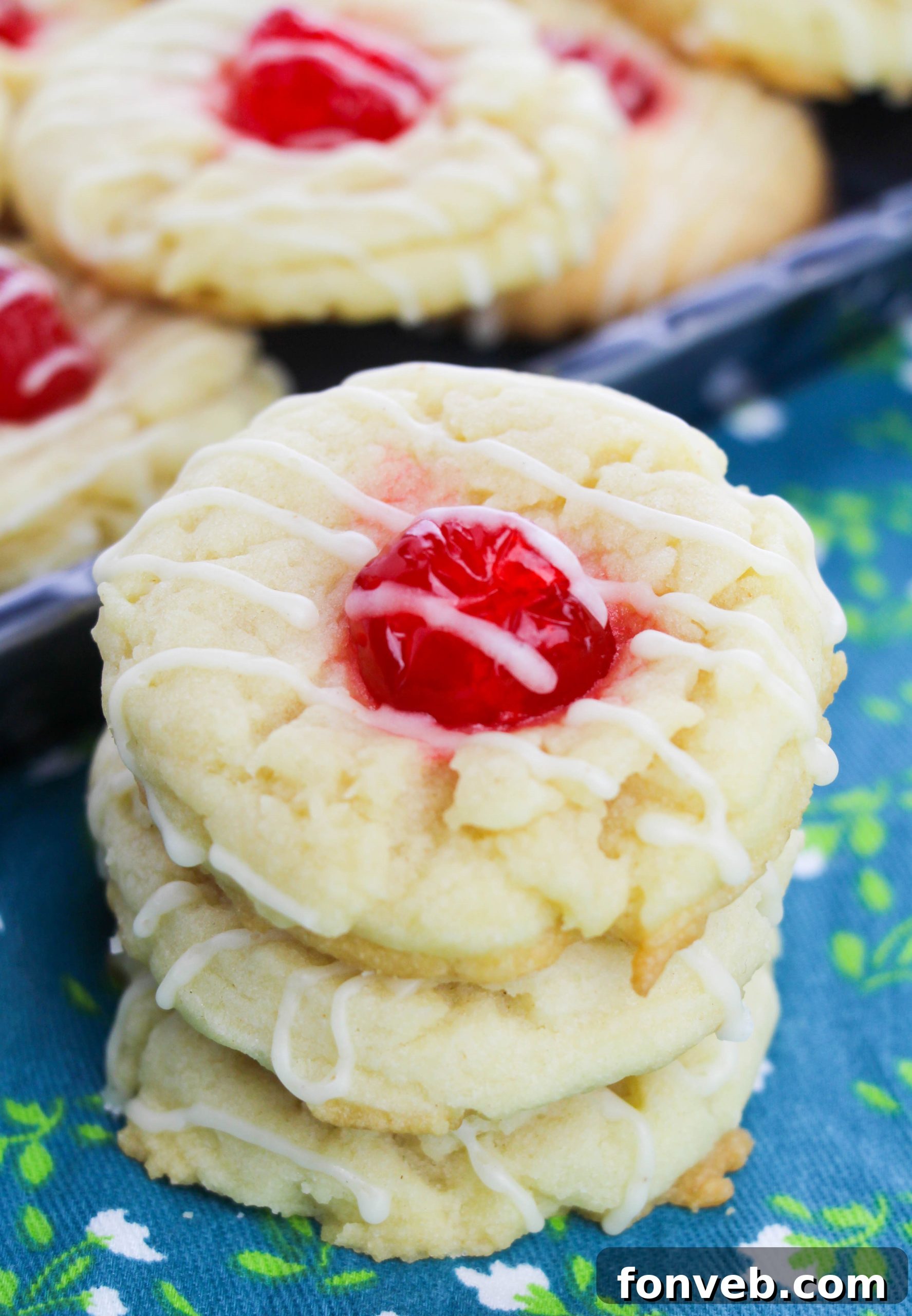 A final close-up of a single Eggnog Thumbprint Cookie, showcasing its rich texture and cherry center