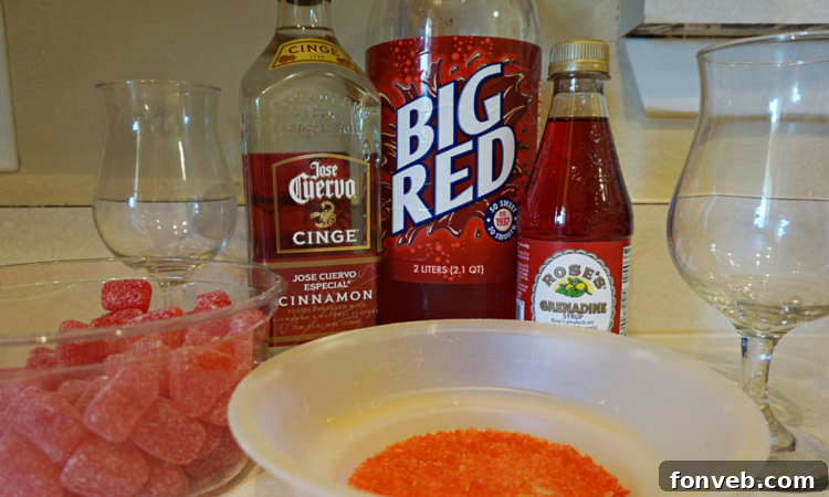 Two glasses of Red Hot Love Cocktail garnished with gummy hearts and pop rocks