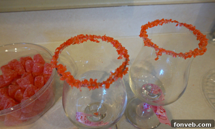 Red Hot Love Cocktail being poured, showing its vibrant red color