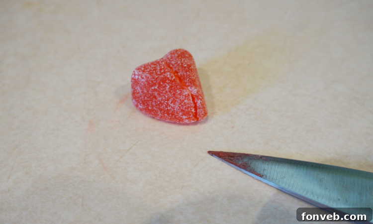 Finished Red Hot Love Cocktail with gummy heart garnish and pop rocks rim