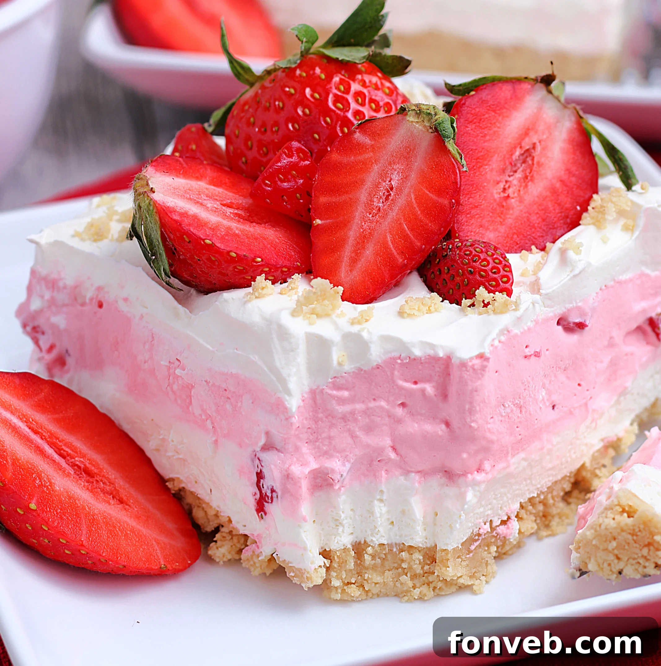 Delicious slice of No-Bake Strawberry Cheesecake Lasagna showing off its four perfect layers