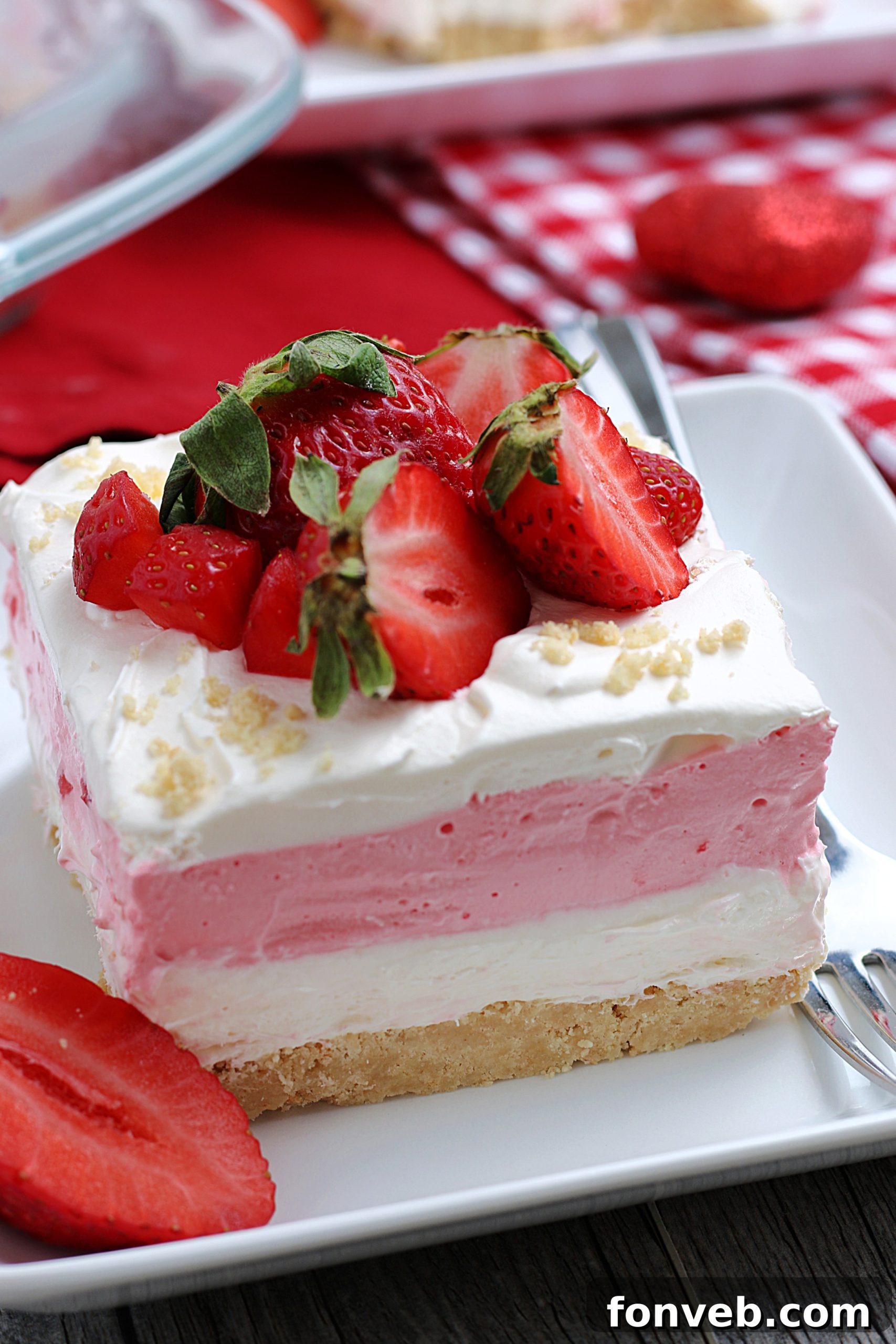 A large pan of freshly made No-Bake Strawberry Cheesecake Lasagna, garnished and ready for chilling