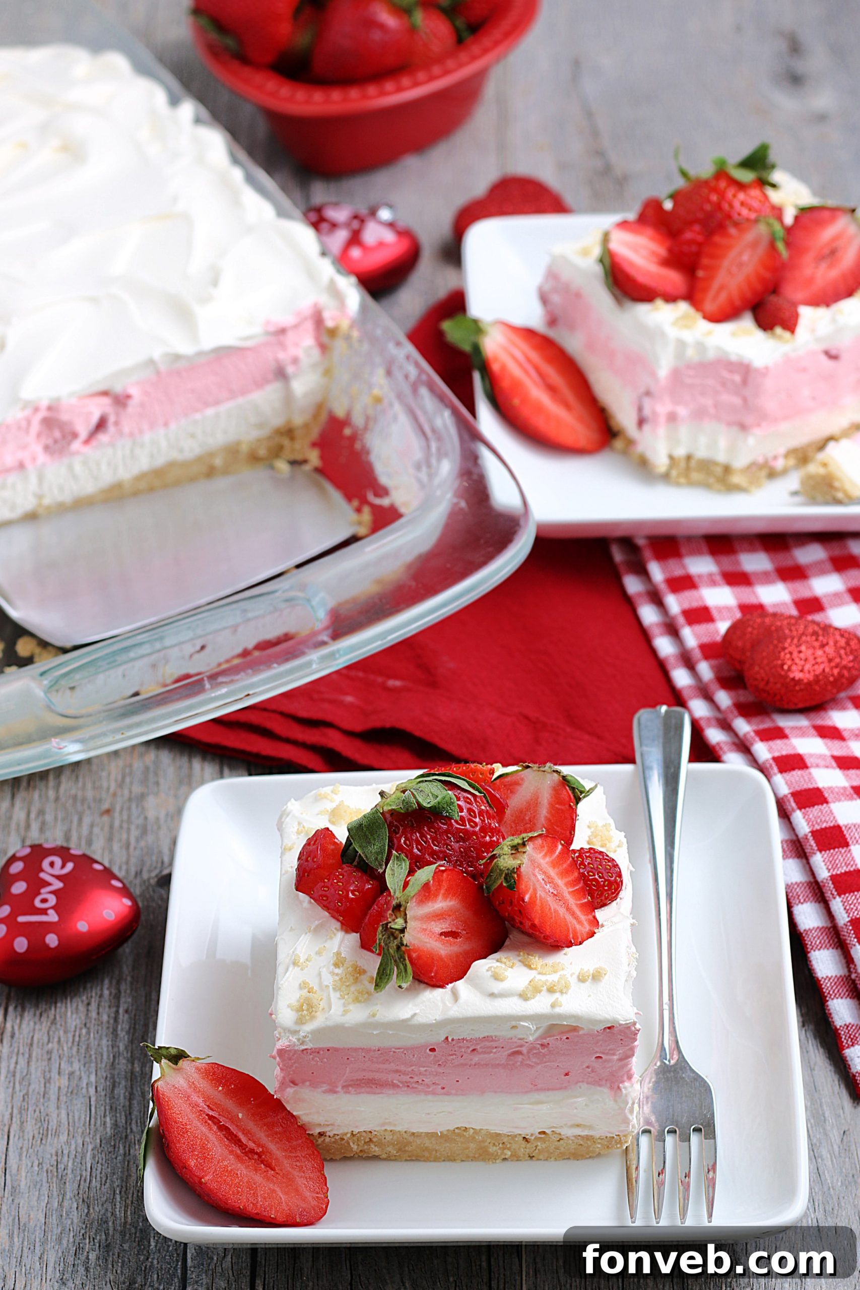 A close-up shot of the perfectly set layers of No-Bake Strawberry Cheesecake Lasagna in a glass dish