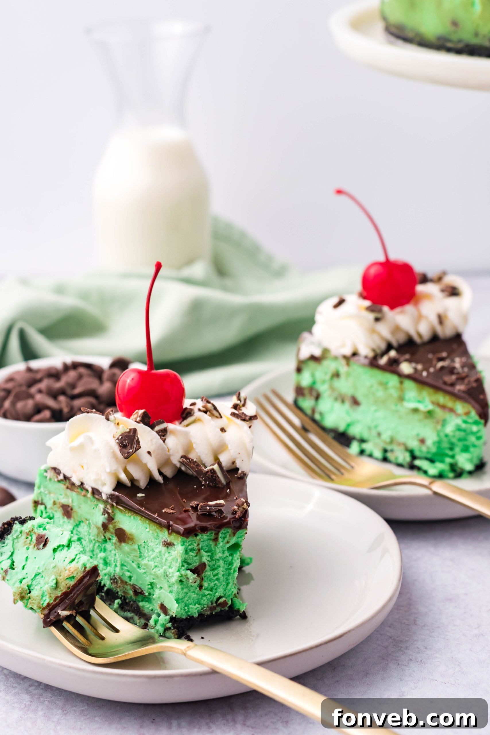 A beautifully garnished slice of Grasshopper Cheesecake, ready to be enjoyed