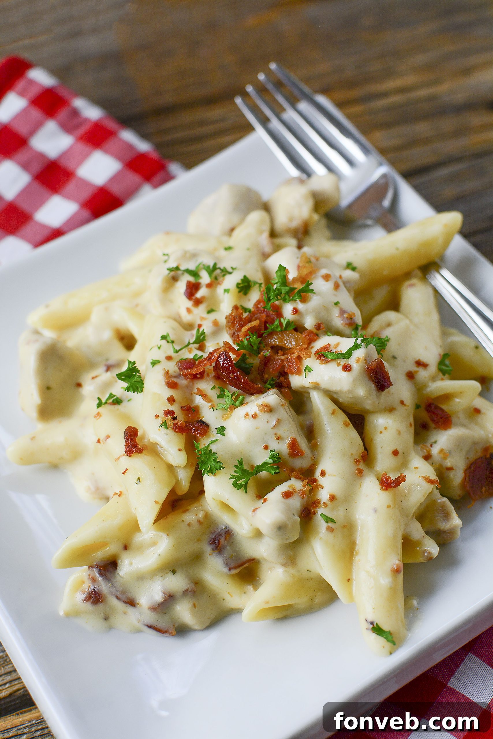 Creamy Instant Pot Crack Chicken Pasta with fresh parsley and generous bacon bits.