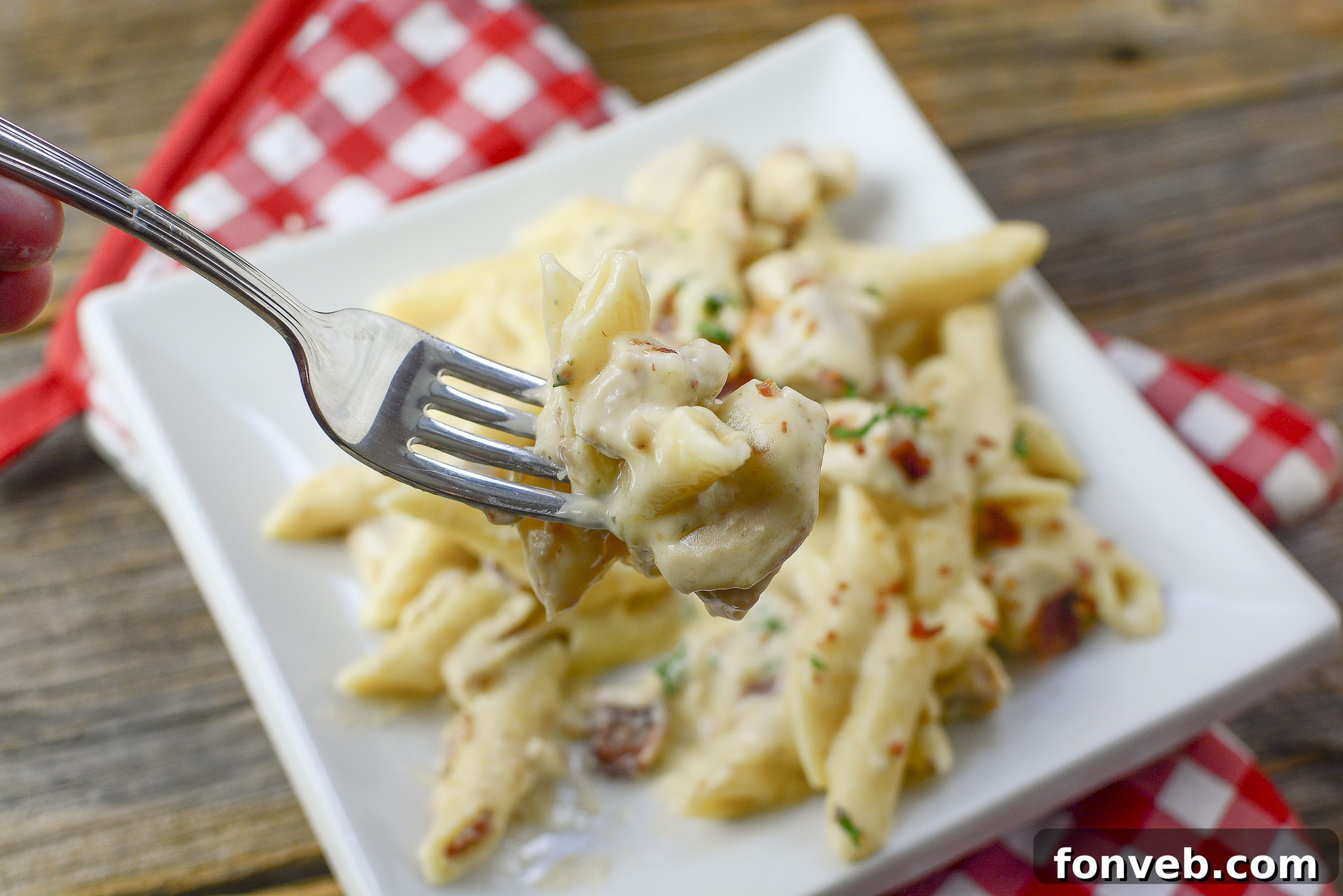 Overhead view of chicken and pasta simmering in the Instant Pot, forming the base of the dish.